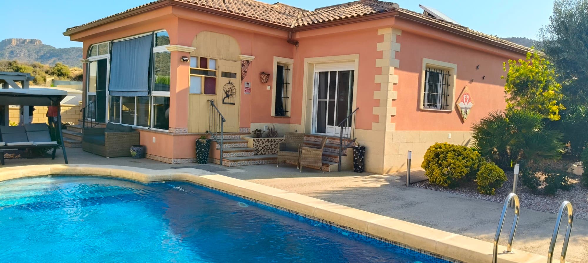 Discover the authentic Spanish lifestyle in this beautifully maintained villa just outside the picturesque village of La Romana, Alicante. Set in a peaceful location with stunning mountain views, yet only a short 2-minute drive (10-minute walk) to the village centre, this home offers the perfect balance between tranquility and convenience.

The villa boasts 145 m² of comfortable living space with 3 spacious bedrooms and 2 modern bathrooms. The master suite is a true retreat, featuring a luxurious ensuite bathroom with a huge walk-in shower and a generous dressing room.

The living room is warm and inviting, complete with both a wood stove and a pellet burner—perfect for cozy evenings all year round. The fully equipped kitchen is ready for your culinary creations, with plenty of space to cook and entertain.

Step outside to a private 542 m² plot filled with charm. A large 32 m² swimming pool invites you to cool off under the sun, while mature fruit trees provide shade and fresh harvests throughout the year. A charming wooden shed offers the ideal spot for relaxing, enjoying a good book, or simply soaking in the panoramic mountain views.

Whether you’re looking for a permanent residence, a holiday home, or a tranquil retreat, this property ticks all the boxes.

Distances:

Alicante Airport – 25 minsLa Romana village – 2 mins walkGolf courses – 15 minsBeaches of Alicante – 35 mins

Don’t miss out on this rare opportunity to own a traditional villa in a sought-after part of the Costa Blanca. Contact us today to arrange a viewing!

