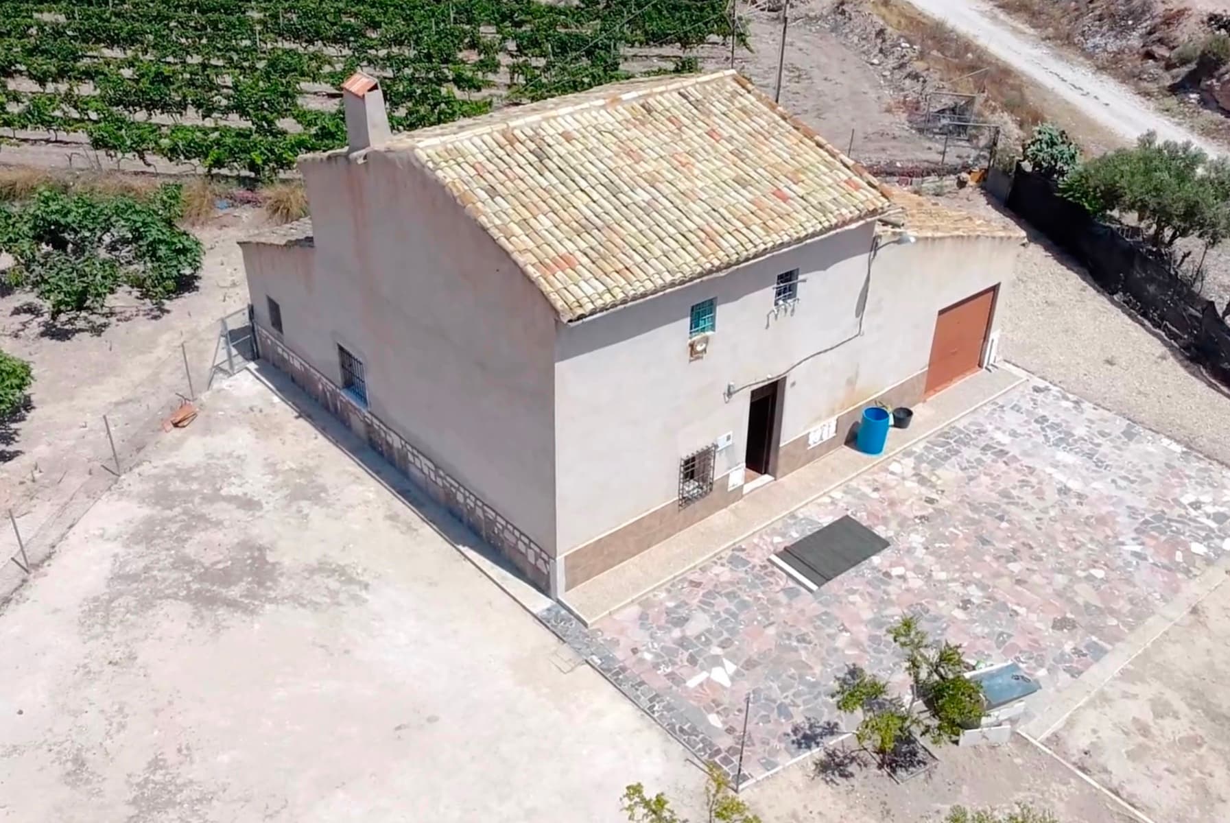 Charming traditional country house to renovate in La Romana, Alicante – 3,200 m² plot with spectacular views Discover a hidden gem in one of the most sought-after towns in inland Alicante: La Romana. Just 35 minutes from Alicante Airport and the beach, this authentic 1904 estate invites you to reconnect with tranquility, history, and nature, while still being close to all essential services. Located on a generous 3,200 m² plot , the property boasts 215 m² of built area spread over two floors that retain original features such as wooden beams and natural stone walls . A solid foundation with soul, ready to be transformed into a unique and personalized home. On the ground floor , there's a large space currently used as a garage, but which could be converted into a stunning living room with high ceilings and exposed beams. There's also an elegant entrance, two bedrooms , and a powder room with enough space to install a full bathroom with double sinks. Upstairs , the potential is endless: you could design a master bedroom with a walk-in closet , a library with a work area, and an additional bathroom. All with natural light and open views of the countryside. The property has a wood stove for heating , a natural cave , and an auxiliary building that could house a future private pool . Located just minutes from the center of La Romana and with quick access to towns like Aspe, Novelda, and Elche , this property offers the best of both worlds: the peace of the countryside and the convenience of urban proximity. Restaurants, shops, and golf are 15 minutes away, while hiking and the Mediterranean beaches are just half an hour away. A unique opportunity for those seeking authenticity, space, and renovation opportunities in a setting of great natural and cultural value. Key distances: 35 min to Alicante Airport 35-40 min to the beaches 6 min to restaurants, bars and shops 15 min to golf courses Hiking and nature areas just minutes away To give you a visualization of what this gem will look like after the renovation, we're developing a renovation project. We're already adding some illustrations, but contact us and we'll give you an idea of our plans.