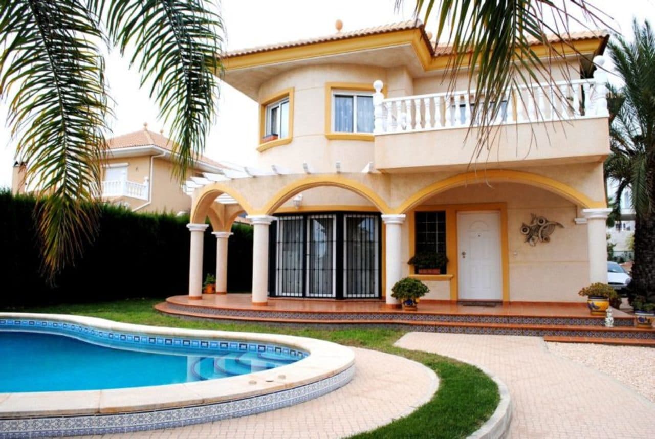 The property itself is situated on a very quiet road, each property having adequate privacy. On approaching the property you notice it has both a pedestrian gate and double gates for vehicles. Once inside the grounds the first thing that stands out is the generously sized swimming pool. Further up the path you will reach the steps up to the porch and reinforced entrance door. You can access the back of the property from the outside as the pathway leads all around. There is a driveway where up to 5 cars can park and leads to the garage with electric door. Stepping inside the property you will be taken aback at the abundantly sized lounge/diner, with working log burning fireplace. This room is very light and airy but most of all spacious. The downstairs bathroom is just off the lounge and is fully tiled with a walk in shower as well as a bidet, w/c and sink. There is also a very large storage cupboard under the stairs. Onward from the lounge/diner, you walk into the kitchen area which is open plan to another great size reception room. The reception room is currently used as another dining area with plenty of space for the whole family and guests! In the kitchen you will find a large integrated fridge/freezer with electric oven and electric hobs, the kitchen also has an exterior door leading to another small terrace and the BBQ area. Through from the kitchen/reception room, you will come to the downstairs bedroom/office with plenty of space for either 2 x single beds or a double. This room is currently being used as an office, This room has the utility area just off from it, the utility area has the washing machine, boiler and plenty of storage space for cleaning appliances etc. Going upstairs on the marble staircase you get to the landing and a patio door to the front facing balcony, here you have incredible panoramic views of La Zenia this is also where you will find the sun in the mornings. Both bedroom ½ are of a good size built in wardrobes and plenty of storage, both bright and sunny. Bedroom 3 the master bedroom is a large room with en-suite bathroom which features his and her sinks, bidet and enormous bath with Jacuzzi jets. This room has a patio door leading to a private balcony where you will find the sun in the afternoon. The family bathroom is fully tiled with bath and additional shower installed.La Zenia is such a sought after location, ideally placed for easy access to fine restaurants, bars with live entertainment, excellent golf courses for the avid golfer and golden beaches for the sun worshipper or swimmer.  For day trips out head north to the inland town of Elche famous for its palms or go south to the Mar Menor where the La Manga Club is located. The historic city of Murcia is not far and here there are a couple of good shopping malls. If you want history, nearby Rojales and Orihuela have old towns and cave houses. Torrevieja is still very Spanish and has wonderful beaches and promenade just some of the interesting places to explore. Just 15 to 20 minutes to Murcia airport it is so easy for holiday makers to travel to. Or if you are living here full time not long to get to the airport to visit relatives in the UK or other European countries.