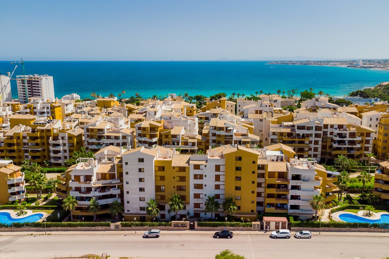 Fabulous 2 bedroom, 1 bathroom 1st floor apartment located in Punta Prima, the perfect location just 100 metres from the Mediterranean sea on the Costa Blanca. Built in 2008 'Parque Recoleta' is a private complex of luxury apartments with stunning manicured gardens, 2 swimming pools, and 24/7 CCTV. Located on the 1st floor this sunny south facing apartment boasts spectacular views across 2 of the swimming pools and out towards the sea with can be enjoyed from the large terrace with plenty of space for sunbathing and dining. Inside you will find a huge lounge and dining area with open plan fully equipped kitchen. The hallway leads to the master bedroom with en-suite bathroom, the guest bedroom with private access to the terrace and the guest bathroom. The property is sold fully furnished as seen and includes a designated parking space in the underground car-park. 'La Entrada' is located in a sought after neighbourhood just a few minutes walk from the beach and the popular restaurant Nautilus. In the opposite direction there are a vast amount of shops, tapas bars, supermarkets, a pharmacy along with numerous international restaurants.