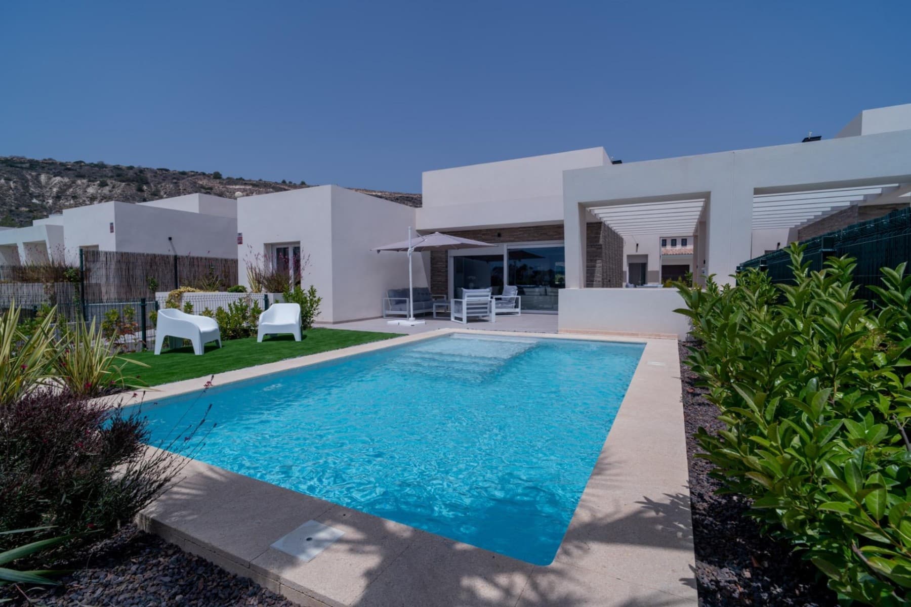 We are delighted to introduce this exceptional luxury villa in La Finca Resort — one of the most exclusive residential areas in Costa Blanca South. Surrounded by peaceful landscapes, Mediterranean nature, and a world-famous golf course, this contemporary home in the new Mar Egeo development offers style, comfort, and high energy efficiency, all under more than 300 days of sunshine each year.Designed on a single main level, the villa also features a spacious and naturally bright basement thanks to its elegant patio-style light wells. The home includes three bedrooms with built-in wardrobes: a stunning master suite with a walk-in closet and private bathroom, plus another bedroom with its own en-suite. In addition, there are two beautifully finished bathrooms and a guest toilet, all equipped with underfloor heating, sleek tempered-glass screens, and fitted mirrors.The open-plan kitchen is a real highlight — modern, elegant, and fully equipped with high-end appliances. It offers generous storage and connects seamlessly to the large living and dining area through a stylish breakfast bar. From here, you can enjoy relaxing views over the private pool, creating a warm, functional, and inviting social space.Large sliding doors lead from the high-ceiling living room to the private garden — your own Mediterranean sanctuary. The outdoor area features a spacious terrace with a built-in pergola, a cosy chill-out space, and a sparkling pool, ideal for long sunny days and tranquil evenings.The villa comes fully furnished and ready to move into, with high-quality furniture and tasteful decoration carefully selected for every corner of the home.A wide range of premium extras is also included:• Central heating and air-conditioning throughout• Smart-home system for climate, blinds, and lighting• Solar panels for greater efficiency and sustainability• Pre-installation for an outdoor barbecue, with water and electricity points• Closed garage for two cars with direct access to the basementThis villa is an outstanding choice whether you're looking for an elegant full-time home or a high-end investment in one of the most desirable areas in southern Alicante.A rare opportunity in a truly privileged location — not to be missed.