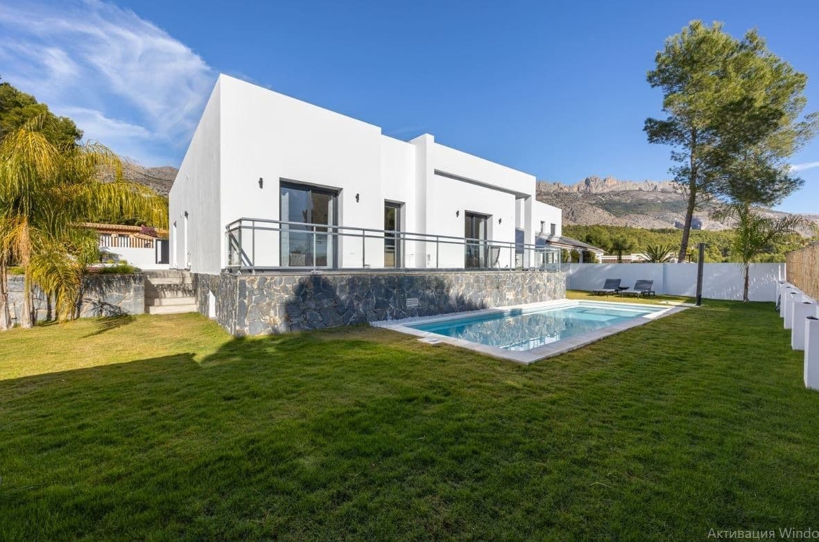 A new 198 m² villa for sale in the town of Altea. The property was built in 2021. The house features three bedrooms, two bathrooms, a guest toilet, a separate kitchen, a living room with a fireplace, and a walk-in wardrobe. From the entrance hall you can also access another part of the house, where there is a spa area with a sauna, shower, and a spacious relaxation room.The house has been finished to a high standard, with every detail carefully thought out. One of the key features of this property is its single-storey layout, which provides maximum convenience and comfort.The plot includes a parking space for a car, a private swimming pool, a lounge area with a sofa and armchairs under a canopy, as well as a barbecue area.When you buy property in Spain, you can apply for a Spanish residence permit. Our company assists with obtaining residence permits of any type.