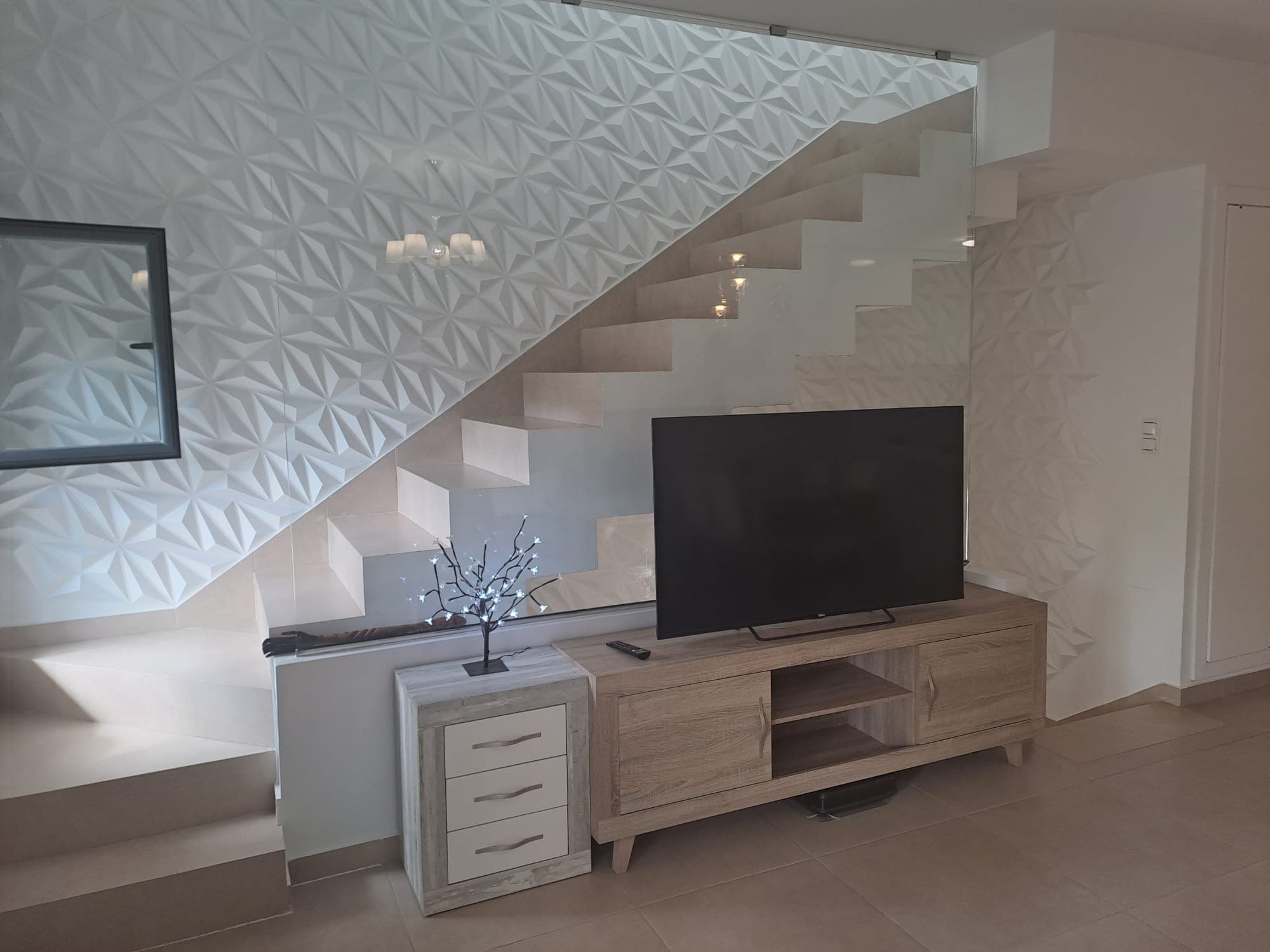 A modern townhouse for sale with a built area of 197 m². The duplex offers three bedrooms, three bathrooms, and an open-plan kitchen combined with the living room. The kitchen has access to a private patio, while from the living room there is a staircase leading down to the basement level, where the garage is located. A rooftop solarium is situated on the roof, and there is an additional terrace at the entrance to the house.The residential complex features two swimming pools (a standard pool and a heated pool).The distance to the sea is 3 km.Online reservation is available, as well as mortgage financing from the bank at an annual interest rate of 4–6%.