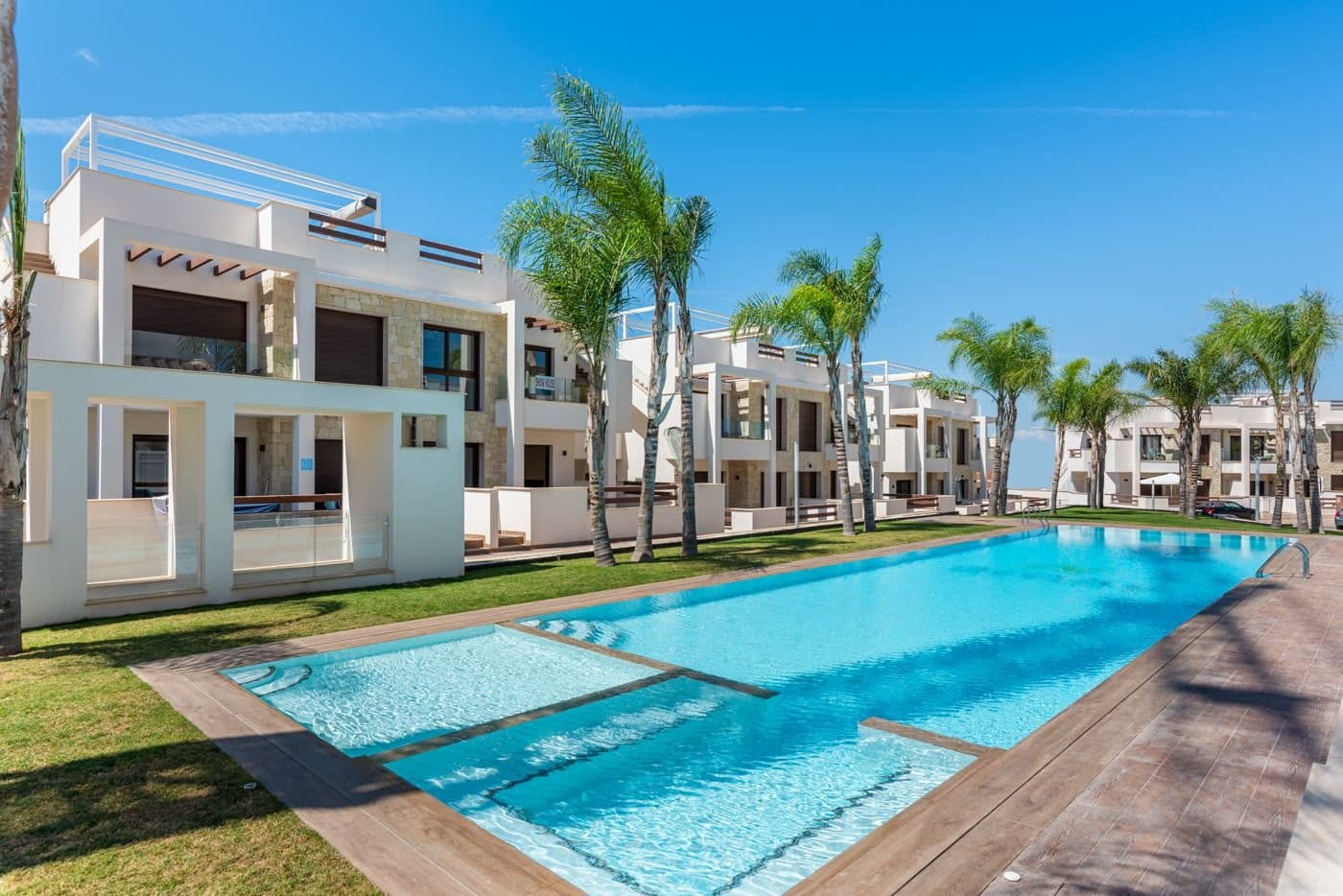 Located in the sought-after area of Los Balcones, near Torrevieja’s iconic pink salt lake, this elegant and move-in-ready penthouse offers the perfect combination of sunshine, peace, and comfort in beautiful surroundings. Built in 2019, it’s an ideal choice for those seeking a stylish holiday home or a smart investment.The apartment features two bright and welcoming bedrooms with built-in wardrobes, as well as two modern bathrooms with sleek finishes and walk-in showers. The open-plan kitchen and living area form a bright, airy space with direct access to a lovely terrace overlooking the lush communal garden and inviting pool area. A pergola on the terrace provides welcome shade during the warmer months.One of the property’s standout features is the impressive 64 m² private solarium – a true oasis under the open sky. Here, there’s room for a dining area, lounge seating and sunbeds with views of the surrounding landscape and the shimmering salt lake. Two pergolas provide adjustable shade, and there’s also an outdoor shower and convenient storage space for cushions and other essentials.The apartment is equipped with ducted air conditioning for both cooling and heating, and all windows and terrace doors feature electric shutters. The property is sold fully furnished and has only been used as a holiday home – you can simply move in and start enjoying it. A private parking space and storage room in the underground garage are also included.The location is ideal – within walking distance to both Mercadona and Aldi, as well as several restaurants and cafés. The nearest sandy beaches are just a 10-minute drive away, and the popular Zenia Boulevard shopping center is only 10–12 minutes by car. Golf lovers will appreciate the close proximity to several renowned courses including Villamartin, Las Ramblas, and Campoamor – all within approximately 15 minutes. Alicante Airport can be reached in just 40–45 minutes via the motorway.This property combines modern comfort with a relaxed holiday atmosphere and an unbeatable location. It’s the perfect base for vacations, year-round living, or rental investment. Here, you can enjoy sunshine, stunning views, and a high quality of life – all year round.Don’t miss the chance to view this wonderful penthouse in the sought-after Balcones de Amay complex – book your visit today!