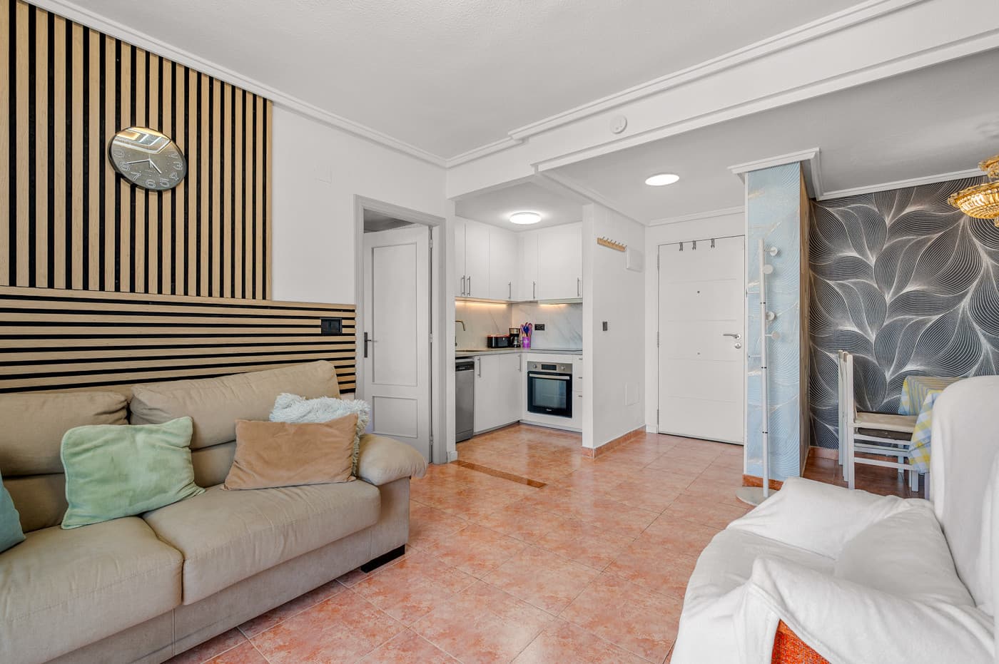 This bright and spacious apartment is located on the 4th floor of a well-maintained building with lift – right in the heart of Torrevieja, yet still offering an open view from the balcony. It combines a central location with modern comfort.Originally built in 2001, the apartment has just undergone a complete renovation and now feels almost brand new. It offers three good-sized bedrooms and two bathrooms. The kitchen has been fully refurbished with new fittings and appliances and is open to the living room, which has direct access to a lovely balcony. Here you can enjoy the Mediterranean climate all year round – perfect for morning coffee or warm summer evenings.As part of the renovation, new windows and modern air conditioning units have been installed, ensuring a pleasant indoor temperature throughout the year. The apartment is sold furnished and is ready to move into.The location is a major highlight. You’ll be living in the centre of Torrevieja with supermarkets, cafés and restaurants within walking distance, and the charming sandy beaches just minutes away. The popular Habaneras Shopping Centre, with a wide range of shops, restaurants and a cinema, is also close by. A short drive takes you to Zenia Boulevard, one of Spain’s largest open-air shopping malls. For golf enthusiasts, there are several renowned courses in the surrounding area, and Alicante Airport can be reached in about 40 minutes.A modern and move-in-ready home offering space, comfort and an excellent location – ideal as a holiday retreat or year-round residence in vibrant Torrevieja.