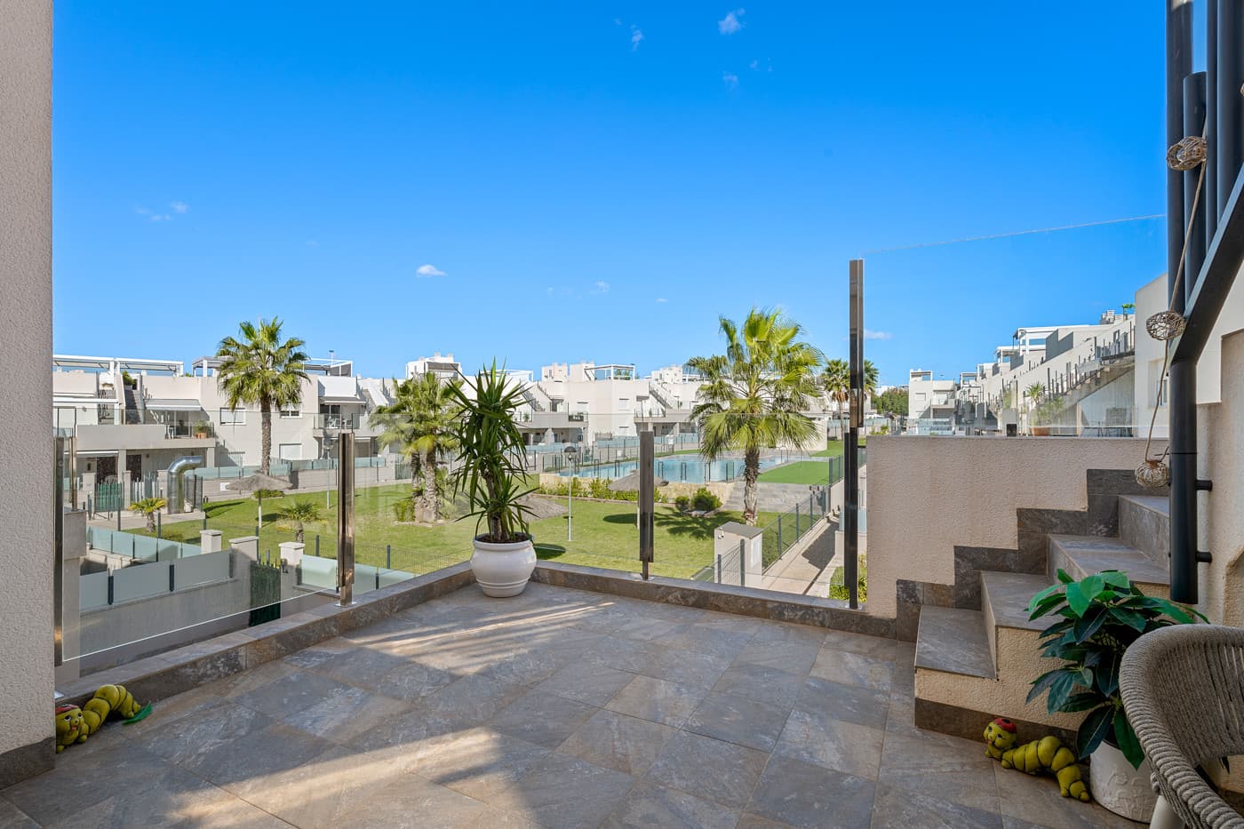 This elegant upper bungalow from 2019 offers a modern and comfortable base in one of Torrevieja&039;s most sought-after areas, namely Aguas Nuevas. The home has 78 m² with two good bedrooms and two stylish bathrooms, one of which is ensuite. There are large built-in wardrobes in both bedrooms, so there is plenty of space for storage.Here is a layout that works perfectly for both year-round use and holiday living.The living room with modern and stylish kitchen as well as living and dining area is bright and well-appointed. From here there is access to a large terrace with views of the common area and one beautiful pool. When you want a little extra freedom and sun, you can simply go up one floor - here a large roof terrace awaits with plenty of opportunities to create your very own outdoor space, whether it is for relaxation, sunbathing or cozy evenings with family and friends.There is also a storage room where both the washing machine and the water heater are conveniently located.The home is being sold furnished with quality fixtures and fittings, so you can move in without any hassle.The central air conditioning system ensures a comfortable temperature regardless of the season. There is underfloor heating in both bathrooms.A large private parking space in the underground parking garage is included in the price – a clear advantage in the area.The complex is fenced and well-maintained and offers two communal pool areas, one of which has a heated jacuzzi.In addition, there are green areas and a playground, making the surroundings safe and pleasant for both adults and children.The location is a big plus. Here you live within walking distance of Mercadona, cafes and restaurants – all within easy reach when everyday life or vacation needs to work smoothly. La Mata beach is only a few minutes away by car or bike, and Alicante Airport can be reached in approximately 40 minutes, making travel days a breeze.It is quite simply a home that combines move-in quality, good outdoor areas and an attractive address near the beach and amenities.An obvious option for those who want a home with both comfort and a top location on the Costa Blanca.Please contact us for more information or if you would like a viewing.