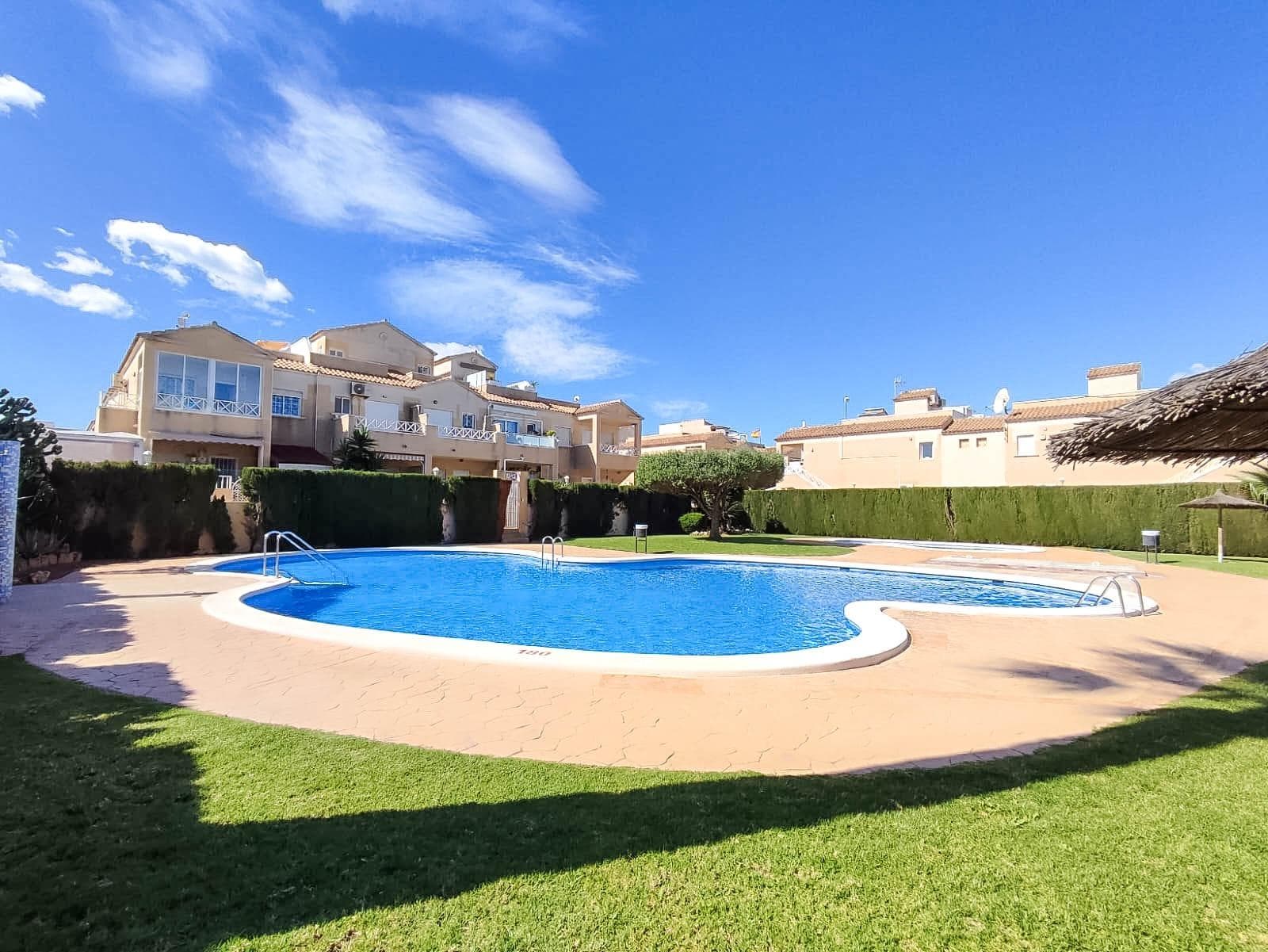 Bright and fully furnished 2-bedroom penthouse bungalow with a spacious 26 m² rooftop solarium and a private 53 m² plot, located in the gated community "Europa" with a swimming pool and green park Address: Calle Ramón Imbernón Verdú, Torrevieja — an ideal central location: opposite the Consum supermarket, near Carrefour, Habaneras shopping center, shops, cafes, and all urban infrastructure within walking distance Property Features: - Living area: 61 m² - Entrance terrace: 10 m² with installed awnings - Private front plot: 53 m² with gate and parking - Rooftop solarium: 26 m² - Separate garage with electric gate (optional) - 2 bright and cozy bedrooms - Separate fully equipped kitchen - Glazed laundry area next to the kitchen - South-facing windows — maximum sun all year round - Fully furnished with appliances - Air conditioning for heating and cooling - Fresh paint, quality curtains, chandeliers, and security bars on the windows The property is situated in a well-maintained residential complex with a pool, green areas, and a cozy, secure atmosphere. Ideal for year-round living, a holiday home, or rental investment Don't miss the chance to acquire a ready-to-move-in home in the center of Torrevieja with excellent infrastructure and sunny comfort!