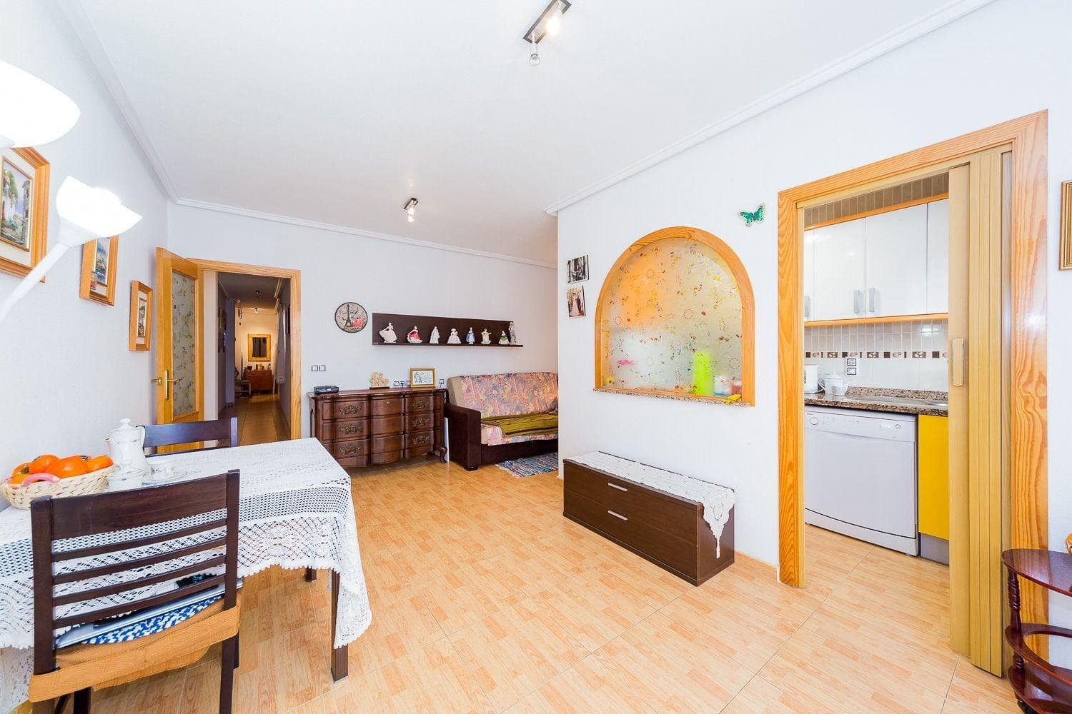 Apartment for sale: spacious living room with balcony and open-plan kitchen, two separate bedrooms with built-in wardrobes, and a full bathroom. Total apartment area: 86 m², living area: 76 m². The apartment is located in the quiet center of Torrevieja, on the 3rd floor of a 5-story building constructed in 2008, near the Parque de las Naciones, at 4 San Luis Street. The sandy Acequión beach is 400 meters in a straight line. Everything is nearby: school, park, buses, shops, and cafés. It is sold fully furnished, with appliances and air conditioning.