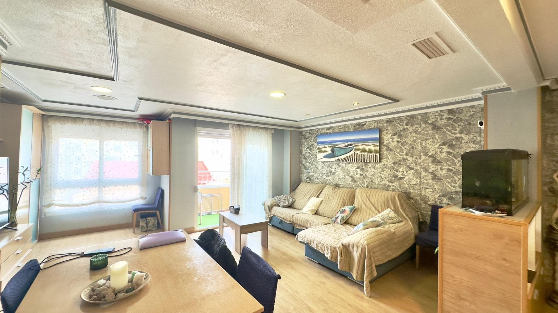 Spacious apartment on San Pascual Street, in the heart of Torrevieja, designed for those who need real space without sacrificing the convenience of being in the city center. Four bedrooms and two bathrooms make this apartment a true family home, a place where everyone can have their own space, their own pace, and their own privacy, while also sharing moments in the common areas. Furnished and ready to move in, it's ideal for large families, those who work remotely and need several rooms, or those who frequently receive visitors and want to accommodate them comfortably. From the moment you enter the building and go up to the apartment, you'll feel that classic urban center apartment, with generous spaces and rooms that feel lived-in, designed to be enjoyed. Upon opening the door, you're greeted by an entrance hall that leads to the rest of the apartment and sets the tone: a home where there's room for everyone, from a large family to a couple who want to combine living and working from home. It's the kind of apartment that allows you to think long-term, about years of memories, gatherings, celebrations, and routines. The separate kitchen becomes one of the home's strongest features. Separated from the living room, it allows for peaceful cooking, keeping things tidy, and focusing on the ritual of eating without mixing smells and noises with the rest of the living area. It's easy to imagine daily life: early breakfasts for all family members, with cups, toast, and quick conversation; leisurely lunches, perhaps following a traditional recipe; impromptu dinners, where the aroma of a stew, pasta, or a baked dish fills the air. The kitchen is not just a functional space; it's the quiet heart of many everyday scenes: someone preparing a late-night coffee while the rest of the house is already resting, or a quiet moment of conversation between two people while everyone else is in their rooms. The living-dining room is the true social hub of the apartment. Everyone gathers here: it's the space for watching a movie as a family, celebrating birthdays, setting a large table for special occasions, welcoming friends for the day, or relaxing after a day at the beach or at work. It's easy to imagine a spacious sofa, a generous dining table, a TV area, and a reading nook with a comfortable armchair. This layout allows for many configurations: from a more formal space to a more relaxed one, always with the idea that it's the place where the best conversations and moments are shared. The four bedrooms offer a flexibility that few homes provide. The master bedroom can become a true personal sanctuary, a spacious area for deep rest, decorated with soft tones, pleasant textiles, and details that invite you to disconnect. The other three bedrooms can cover practically any need: rooms for children with their desks and belongings, rooms for guests who come from out of town to spend a few days on the coast, or even rooms dedicated to remote work, a home gym, a playroom, or a study. In a city like Torrevieja, where many combine work and leisure time, having so many rooms opens up a huge range of possibilities. The two bathrooms distributed throughout the home make daily life much smoother. In a large family, having two separate bathrooms prevents endless waits in the morning and reduces stress during peak hours. Everyone can organize themselves at their own pace: early showers, personal care routines, getting ready to go out—everything becomes simpler. At night, these spaces become places to disconnect: a bit of hot water before bed, a moment of silence when the rest of the house is quiet.