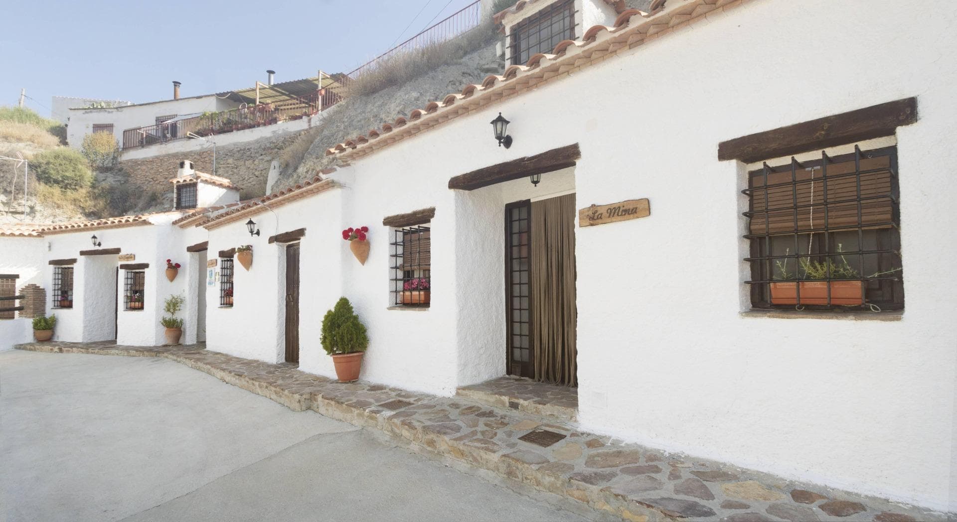 Located in the heart of the Granada Geopark, this exceptional tourist complex offers a unique investment opportunity in the charming village of Castilléjar.  Key Features •Total area: 415 m² (181 m² habitable across three cave houses) •Accommodations: 8 double rooms across three fully equipped caves •Common areas: Spacious recreation areas, two barbecues, private parking, and a laundry room with industrial washing machines •Outdoor space: 300 m², suitable for parking or the potential addition of a pool •Activities & Entertainment: Hiking, biking, water sports, and various outdoor adventures in the surrounding natural parks •Strategic location: South-facing with stunning views of the Sierra de Baza, Sierra Nevada, and the Castilléjar River The Cave Houses Cueva La Cuadra – Sleeps 4 (+2 extra beds) •2 double bedrooms (1 with a double bed, 1 with twin beds), both with fitted wardrobes and a bathroom •Bright living room with a fireplace and fully equipped independent kitchen Cueva La Lumbre – Sleeps 6 (+2 extra beds) •3 double bedrooms (1 with a double bed, 2 with twin beds) and a bathroom •Open-plan living room with a fireplace and a fully equipped kitchenette Cueva La Mina – Sleeps 6 (+2 extra beds) •3 double bedrooms (1 with a double bed, 2 with twin beds) and a bathroom •Spacious living room with a fireplace and fully equipped independent kitchen Additional Facilities •Laundry room (located between Cueva La Lumbre and Cueva La Mina) with two industrial washing machines •Storage rooms (for linens, towels, cleaning supplies, firewood, and extra beds) •Two shared barbecues in a covered porch area for guests to enjoy outdoor dining •Private parking with ample space and the potential to add a swimming pool A Thriving Tourism Business This registered rural tourism complex, officially listed with the Ministry of Tourism of the Junta de Andalucía, has an outstanding reputation, boasting a 9.8 rating on Booking.com. With the growing demand for authentic rural tourism, this property presents an excellent investment opportunity  Prime Location & Accessibility •Situated within the urban area, yet secluded in a quiet, no-through-traffic neighborhood •Sun-drenched south-facing aspect with panoramic mountain and river views •Convenient access to local attractions, restaurants, and outdoor activities •Castilléjar is a lovely little unspoilt village with beautiful surrounding scenery - the spectacular badlands, the Jabalcón mountain and Baza and Granada mountain ranges. It has all the usual facilities as well as a market on Saturday mornings. •There is a huge open air swimming pool in the adjoining hamlet of Los Olivos (5 mins drive by car) open during the summer months. A great place for outdoor activities, art and photography, etc. •It is around 1h30 to the coast and just 40 mins/45km drive away from the beautiful Embalse de Negratin which has beach areas. •The nearest airport is Granada which is approximately 1h35 drive away (125km), Murcia 1h55 (168km) then Almeria 2h (188km), Alicante 2h40 (240km) and lastly Malaga 2h40 (247km). Don’t miss out on this unique chance—contact us today for more details or to schedule a viewing!