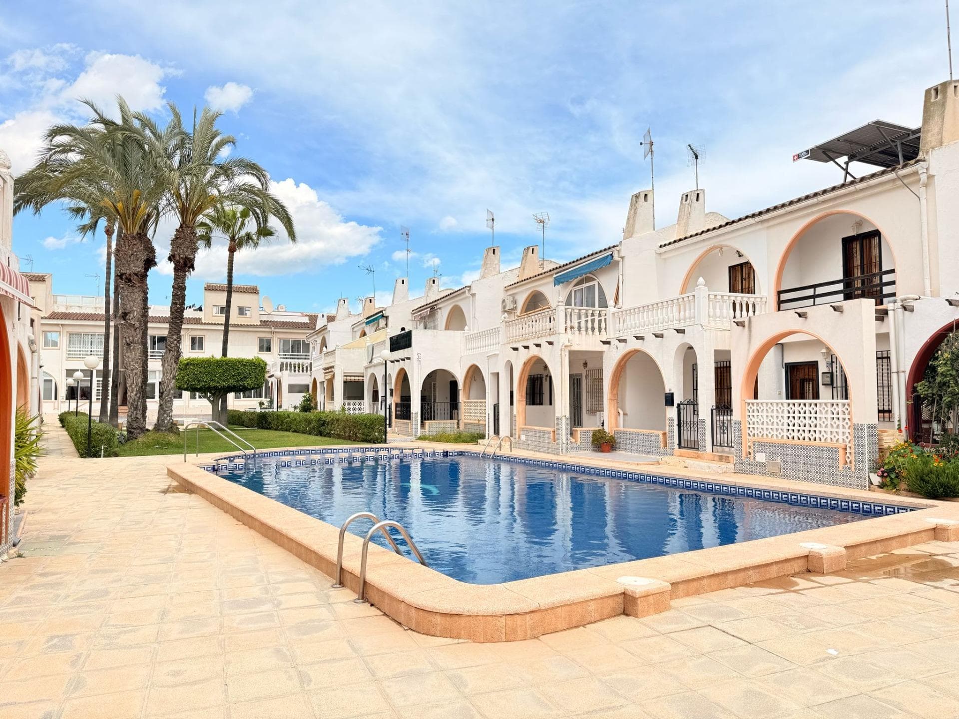 2 bedroom townhouse with a swimming pool in el Chaparral,Torrevieja  PROPERTY:  This townhouse is withinside the gated residential region disbursed into 2 floors. Once we step withinside the housing we´re withinside the closed porche/terrace with a chimney wherein the BBQ might be done. The living-region is hooked up to an open-plan kitchen fully-equiped.On the identical ground we discover a laundry room and a toilet. On the primary ground, we discover 2 bedrooms, certainly considered one among them has an get admission to to the spacious terrace dealing with the network region and a swimming pool. There is a rest room on the primary ground as well. It´s essential to say that there may be a network swimming-pool and a greenery round it wherein you could take sunbath and relax. The automobile may be parked off-street. LOCATION: Torrevieja is in the province of Alicante (Costa Blanca). It is famous for its Mediterranean climate and its coast. We cannot forget its promenades where we can find some restaurants along the fine sandy beaches. It also has many excellent beaches such as Playa de los Náufragos, Playa de los Locos and Playa de la Mata. Therefore, it is considered a remarkable tourist town where the environment takes an important place as an important tourist attraction. In addition, we can find many shopping centres (Habaneras, La Zenia Boulevard), golf courses, sport centres, hospitals (such as Hospital Universitario de Torrevieja) and airports such as Alicante Airport (35 km away) and Region of Murcia International Airport (43 km away). DISTANCE TO THE BEACH: 3KM DISTANCE TO THE AMENITIES:300M