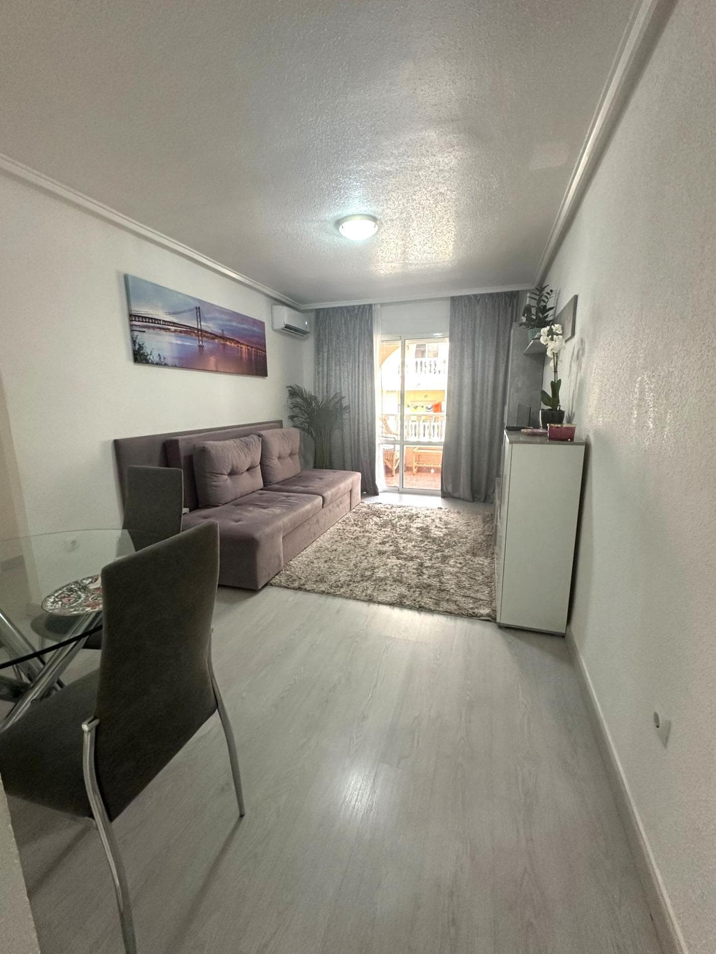 Modern 2 bedroom flat with private terrace, pool and garden in Torrevieja Upon entering this modern refurbished flat, the first thing that strikes you is the natural light that floods every corner. Its south orientation turns the living room into a warm and luminous space throughout the day, ideal to enjoy moments of relax or to spend time with friends. From here, there is direct access to a large private terrace, perfect for having breakfast in the sun, reading a good book or watching the sunset with a glass of wine. The property has two bedrooms. The master bedroom offers a cosy atmosphere, with a built-in wardrobe for extra comfort. The second bedroom, equally bright, is ideal as a guest room, office or children's room. The fully equipped kitchen blends in perfectly with the modern style of the flat, offering a practical and aesthetically pleasing space. The bathroom has been renovated with high quality materials, combining elegance and comfort. But without a doubt, one of the most attractive features of this flat is its surroundings. It is part of a well-kept residential complex with a communal swimming pool and large garden areas, where you can breathe in the tranquillity. An ideal place for those looking for quality of life without giving up the comforts of a modern home. LOCATION: Torrevieja is in the province of Alicante (Costa Blanca). It is famous for its Mediterranean climate and its coast. We cannot forget its promenades where we can find some restaurants along the fine sandy beaches. It also has many excellent beaches such as Playa de los Náufragos, Playa de los Locos and Playa de la Mata. Therefore, it is considered a remarkable tourist town where the environment takes an important place as an important tourist attraction. In addition, we can find many shopping centres (Habaneras, La Zenia Boulevard), golf courses, sport centres, hospitals (such as Hospital Universitario de Torrevieja) and airports such as Alicante Airport (35 km away) and Region of Murcia International Airport (43 km away). DISTANCE TO THE SEA: 600m COMUNITY: 360 €. IBI: 220 €. Should you have any question do not hesitate to contact us!