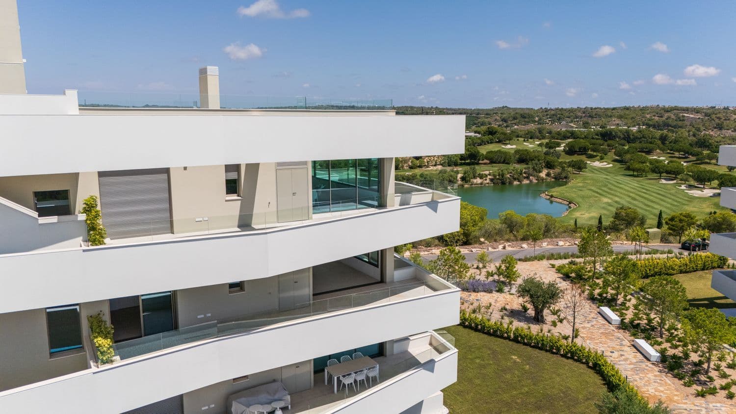 This beautifully designed three-bedroom, two-bathroom apartment is located in the prestigious Madroño community, one of the most sought-after enclaves within Las Colinas Golf & Country Club. Positioned to take full advantage of its elevated setting, the apartment offers sweeping views across the golf course, the surrounding hills and greenery, and on clear days, even a glimpse of the Mediterranean Sea in the distance. The property is part of a low-density development where design and space have been prioritised. The primary bedroom features a luxurious en-suite bathroom, while the two additional bedrooms share a second full bathroom. The open-plan living, kitchen, and dining area is zoned with intelligent design, including an integrated dining table built into the kitchen island — perfect for both everyday living and entertaining. The interiors combine contemporary elegance with natural warmth. Earthy tones, wood-panelled feature walls, designer lighting, and high-end materials create a sophisticated yet welcoming feel throughout. Lighting details have been meticulously considered, with soft illumination from integrated fixtures, including along the skirting boards, enhancing the apartment’s unique and high-quality finish. A standout feature is the generous outdoor space. Two large terraces extend the living area and invite you to enjoy the peaceful surroundings, morning sun, or evening breezes — ideal for dining alfresco or simply relaxing in privacy. Included in the price is an underground parking space and a private storage room. Residents of Madroño enjoy access to beautifully landscaped communal areas, a large swimming pool, and a modern gym — all designed to complement the natural setting.