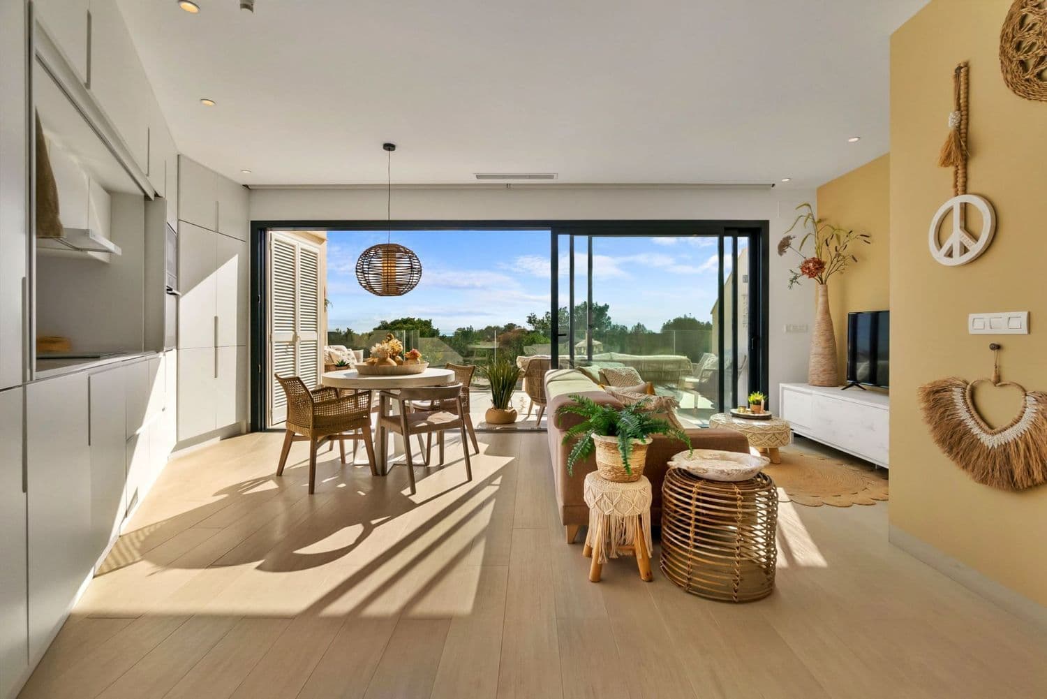 2 bedroom Hinojo apartment in Las Colinas Golf If you dream of a luxury home on Las Colinas Golf and Country Club in the most favorable climate of Spain, we offer you this furnished dream apartment in Community Hinojo 1 on the second floor. When you enter here, you are welcomed by a warm and cozy ambiance. This south facing apartment is lovingly furnished and decorated in Ibiza Style. The living room has three large windows across the entire width, all of which can be slid open so that the terrace with the same tiled floor becomes an extension of the living room. From this terrace with cozy lounge set, you can enjoy a magnificent view with lots of greenery (forest), sea and the Mar Menor with the Manga. The kitchen is equipped with luxury Bosch appliances and can be completely closed off to a wide white wall. There are two bedrooms with large fitted wardrobes and extra storage space under the beds. The Master bedroom has a luxurious bathroom en suite, the second bedroom also has its own separate bathroom. The apartment includes underground parking and private storage room. Major advantages of this apartment are: Fully furnished South facing terrace Very well and cleanly maintained As new; no damage or defects Fantastic view Fully situated on the sunny South The terrace is enclosed with glass walls so that you also have a full view while sitting Air conditioning in all rooms Filtered drinking water Washing machine / dryer available in the outdoor cupboard Las Colinas Golf & Country Club A World Apart! Las Colinas Golf & Country Club is one of the most prestigious resorts on the Costa Blanca! It is an exclusive and unique 330 hectare golf resort with many sports facilities including golf, padel, hiking, fitness, yoga and much more. It is A World Apart where you can enjoy a healthy Mediterranean lifestyle. With an exceptional climate and first class services, the resort has been recognised as “Spain’s and Europe’s Leading Villa Resort” by the World Travel Awards in recent years. Nestled among the hills of the Dehesa de Campoamor – on the Mediterranean coast south of Alicante – Las Colinas Golf & Country Club is a unique natural area that has been carefully preserved and where exclusive homes have been integrated into the surroundings where you can relax and enjoy the scenery. This resort, with some excellent restaurants and the Wow Beach by Las Colinas has an international reputation and is well known and sought after by celebrities. Find your dream home today by taking a look at the most beautiful and exclusive homes we have to offer!