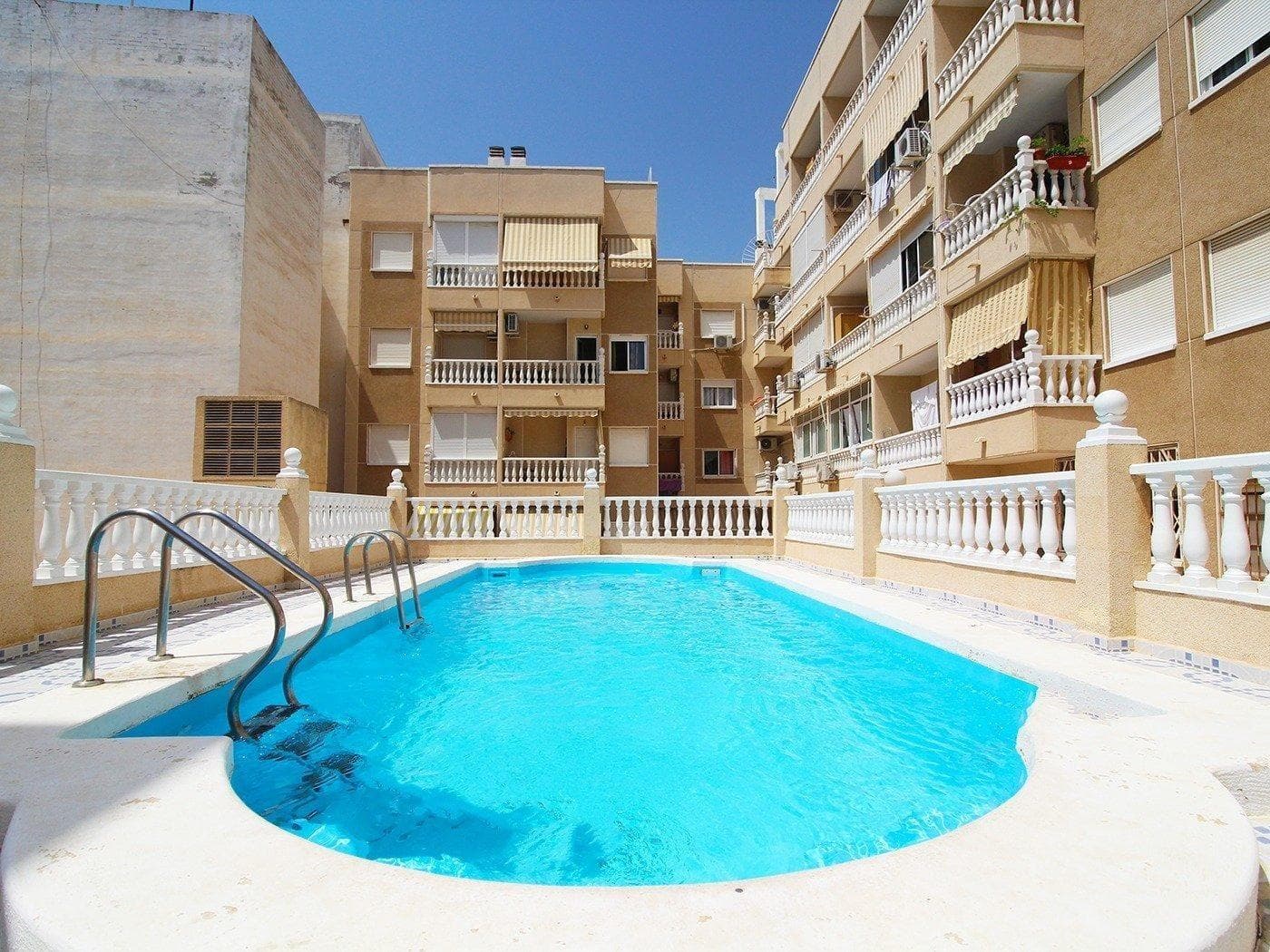 Apartment in Torrevieja center, about 500 m from the beach “Playa del Cura”, the Promenade and the Natural pools, with community swimming pool. It consists of a living room with access to the terrace, a fully equipped separate kitchen, a double bedroom, a simple bedroom and a bathroom. South facing! Furnished. Built-in wardrobes in the bedrooms. Lift in the building. In good condition. Perfect location, close to all amenities, restaurants, cafes, supermarkets, shops, the seafront Promenade, the Natural pools, the main bus station, ... Ready to move in, enjoy the beach and the beautiful Mediterranean climate. And very close by, you can park your vehicle in the Virgen del Carmen underground parking!