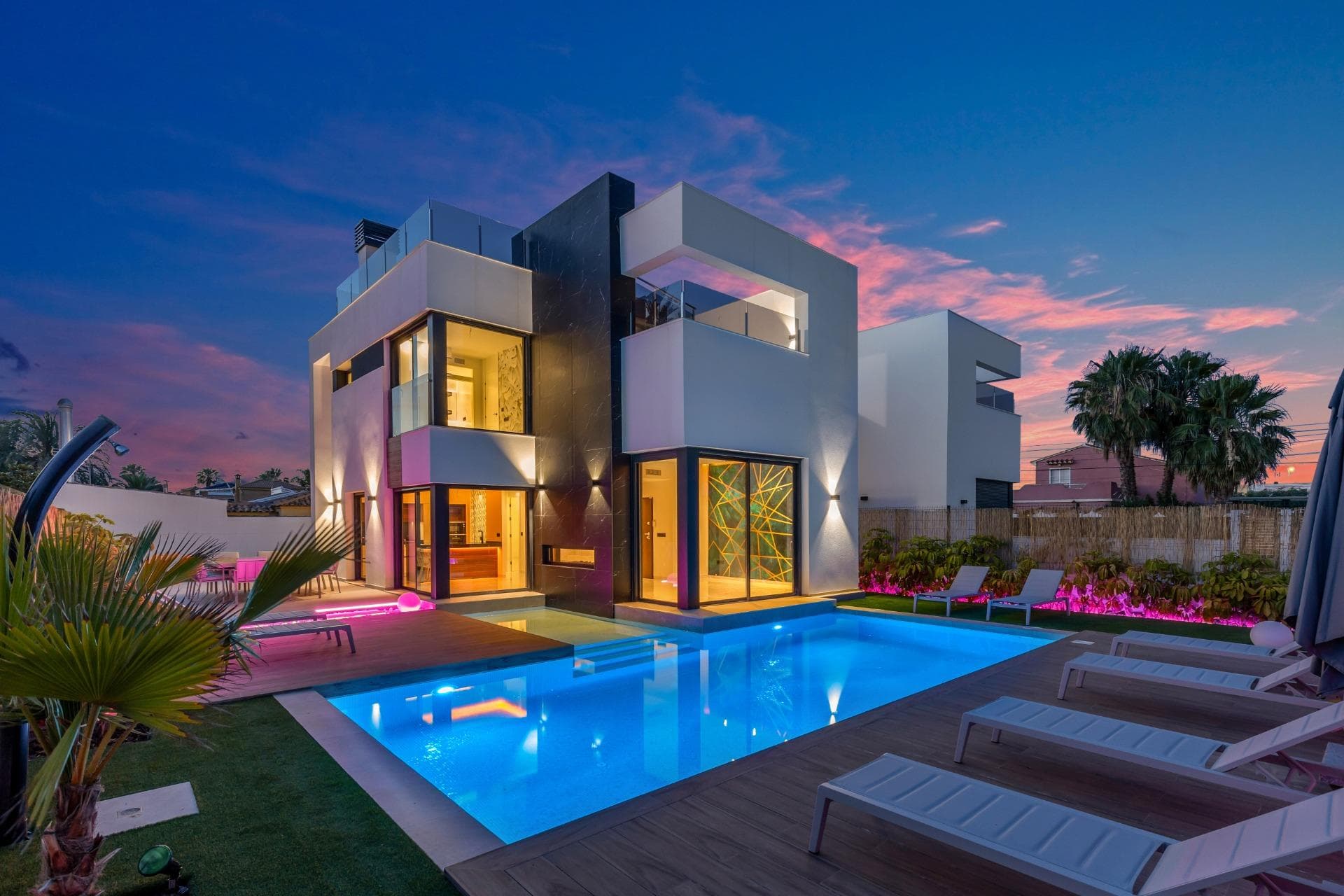 Looking for a home that truly has it all? Welcome to this stunning detached villa in one of the most exclusive areas of Torrevieja, where sleek modern design meets smart, comfortable living. Yes, you read that right — this isn’t just a house… it’s the house. ✨ Main Features: ✅ Key ready ✅ Private pool with heat pump and waterfall feature ✅ Fully integrated smart home system – control everything from your phone ✅ Underfloor heating in bathrooms ✅ Central air conditioning ✅ High-end Bosch appliances ✅ Hot water via aerothermal system ✅ Electric shutters and LED lighting in the kitchen, living room and garden ✅ Luxury finishes: black porcelain marble, solid wood wardrobes, exterior thermal insulation paint, and premium fiberglass windows ✅ Decorative lake with waterfall at the entrance (yes, an actual lake!) 🛏️ Layout: Plot size: 444 m² Built area: 126 m² over 2 floors + solarium 3 bedrooms (1 on the ground floor, 2 en-suite upstairs) 3 bathrooms Spacious living room with open-plan designer kitchen Covered terrace and porch Chill-out area Spectacular private pool 46 m² private solarium with jacuzzi and open views 🌴 Outdoor oasis Step into your own paradise with a beautifully landscaped garden, private pool with waterfall, outdoor chill-out zone, and plenty of space for parking. Outdoor furniture included – all ready for you to enjoy the Mediterranean sun in style. 📍 Unbeatable Location Just minutes away from the best beaches on the Costa Blanca, this villa sits in a quiet and privileged residential area, with all amenities within easy reach: 🛍️ 3 minutes from Habaneras shopping centre 🛒 Close to supermarkets and local shops 🌊 A short drive to the beach 🎢 Near the water park and skate park 🚶‍♂️ All the peace and privacy you want, with everything just around the corner 🧠 Smart tech meets lifestyle Thanks to its advanced home automation system, you can control lighting, climate, blinds and more – all from your smartphone. 💡 Program your home before you even arrive. It’s not science fiction, it’s your new everyday life. 📞 Ready to upgrade to the lifestyle you deserve? Contact us now to schedule a visit. A unique gem like this won’t stay on the market for long… this is your moment! *Purchase taxes and additional costs are not included in the listed price.