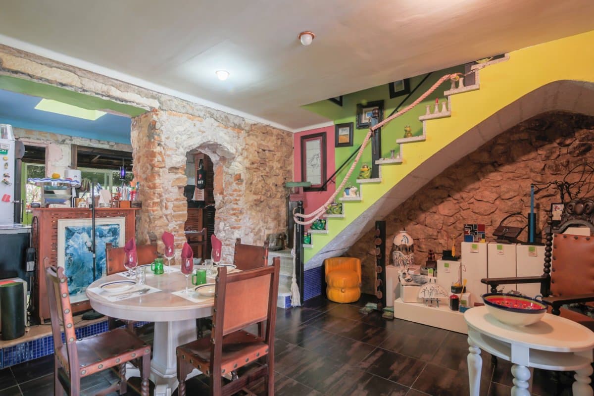 This charming town house with a restaurant business is situated in the heart of San Lorenzo, just a few steps from the town hall, church, schools and the popular "Nova" square of Sant Lorenzo. The property is located on a rectangular plot of land with access from two streets and has three different levels, which adds character and functionality to the structure.. The 2-story house is separated into 2 different uses. On the ground floor there is a restaurant and on the 1st floor, there is a space used as a home (without kitchen).. The ground floor is distributed in an entrance hall with reception, used as an office, dining room for the restaurant with an industrial kitchen with pantry, bar, 3 bathrooms, one for ladies, another for men and the third for staff, a large patio and a wooden terrace. The restaurant is semi-renovated. In the patio of the restaurant, there is a bathroom, a laundry room and a porch.. From the ground floor, you access the first floor where the house is located, distributed in a spacious living room with direct access to a terrace, a loft made of wood, 1 large bathroom with shower and 1 double bedroom.. To the rear of the property, there is a large double garage with 2 storage rooms.. The house and restaurant are sold fully furnished and equipped, ready to continue with business and move into. This setup is ideal for entrepreneurs who want to run their own restaurant while living comfortably on the same property.. Some images have been generated using artificial intelligence to illustrate possible decoration options and showcase the property's potential.. Financial Considerations:. Taxes and Expenses: The property price does not include the taxes corresponding to the purchase, nor the notary and property registration expenses. These additional costs must be.. This property is an exceptional opportunity for those seeking a combination of residential living and a restaurant business in a central and vibrant location. With its multiple levels, access from two streets, and extensive facilities, it offers great potential for both commercial and residential purposes.. Don't miss the opportunity to acquire this versatile and well-located property! Contact us for more information and to organize a visit!