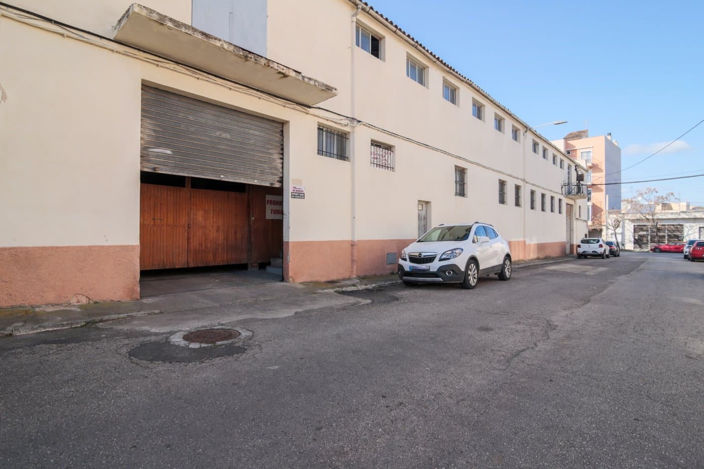 Strategically located on one of the main entrance streets to Manacor. This impressive industrial property is located just a few minutes from the city center.. . With a functional and versatile design, this industrial warehouse offers a unique opportunity for both investors.. . The property is made up of three internally connected industrial warehouses, occupying a corner with access from three different streets. Originally used as a furniture and carpentry factory, which gives it a robust and adaptable structure.. . The property has a first floor. Some areas for storage, high ceilings, several bathrooms, warehouses, warehouses, storage rooms, garage and a large basement.. . The property is ideal for the construction of a shopping center or a car dealership on the ground floor, with the possibility of developing housing on the upper floors. Although it can also maintain its current use as carpentry, in order to benefit from the existing facilities.. . There is the option of acquiring an additional 600 m² warehouse located across the street, perfect for use as a complementary warehouse.. . This property is an excellent opportunity for investors looking for a project with multiple development possibilities.. . We are also builders. Find out with us if you are interested in this property so you can know all its possibilities to build.. . Important: Not included in the price, the corresponding taxes of the purchase and sale, nor the notary and property registration expenses.. . This large industrial warehouse in Manacor not only offers a privileged location and convenient access, but also an adaptable structure for various commercial or residential development opportunities.. . Ideal for investors looking to maximize the potential of their investment in one of the most strategic areas of Manacor. Contact us for more information and to explore all the possibilities this property has to offer.
