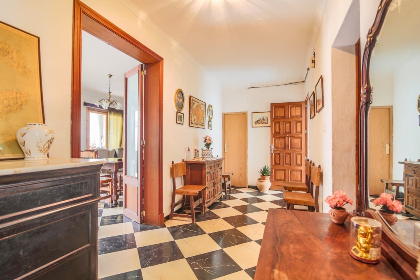 Discover this incredible investment opportunity in the heart of Artà. This building, divided into 3 apartments, is located just 5 minutes walk from the well-known market square, surrounded by local restaurants, supermarkets, pharmacies and shops.. . The property is located on a lot with access from two streets.. . The property is divided into 3 floors. The apartment on the ground floor is distributed in an entrance, hall, three double bedrooms, one of them with a built-in wardrobe, a fully furnished kitchen equipped with appliances, a pantry, a bathroom with a bathtub, a living-dining room with a fireplace, direct access to the patio and garden. with direct access to the garage with a parking space and utility room.. . The apartments on the first and second floor have the same distribution with direct access to the balcony where the laundry room and storage room are located.. . All homes have access to the solarium with unobstructed views of the town. They are also sold furnished and ready to move into.. . Some images have been generated using artificial intelligence to illustrate possible decoration options and showcase the property's potential.. . The taxes corresponding to the purchase, as well as notary and property registration expenses, are not included in the price.. . This property offers a unique opportunity for those looking for a profitable investment or a spacious home in a prime location. Don't hesitate to contact us for more information or to schedule a visit!