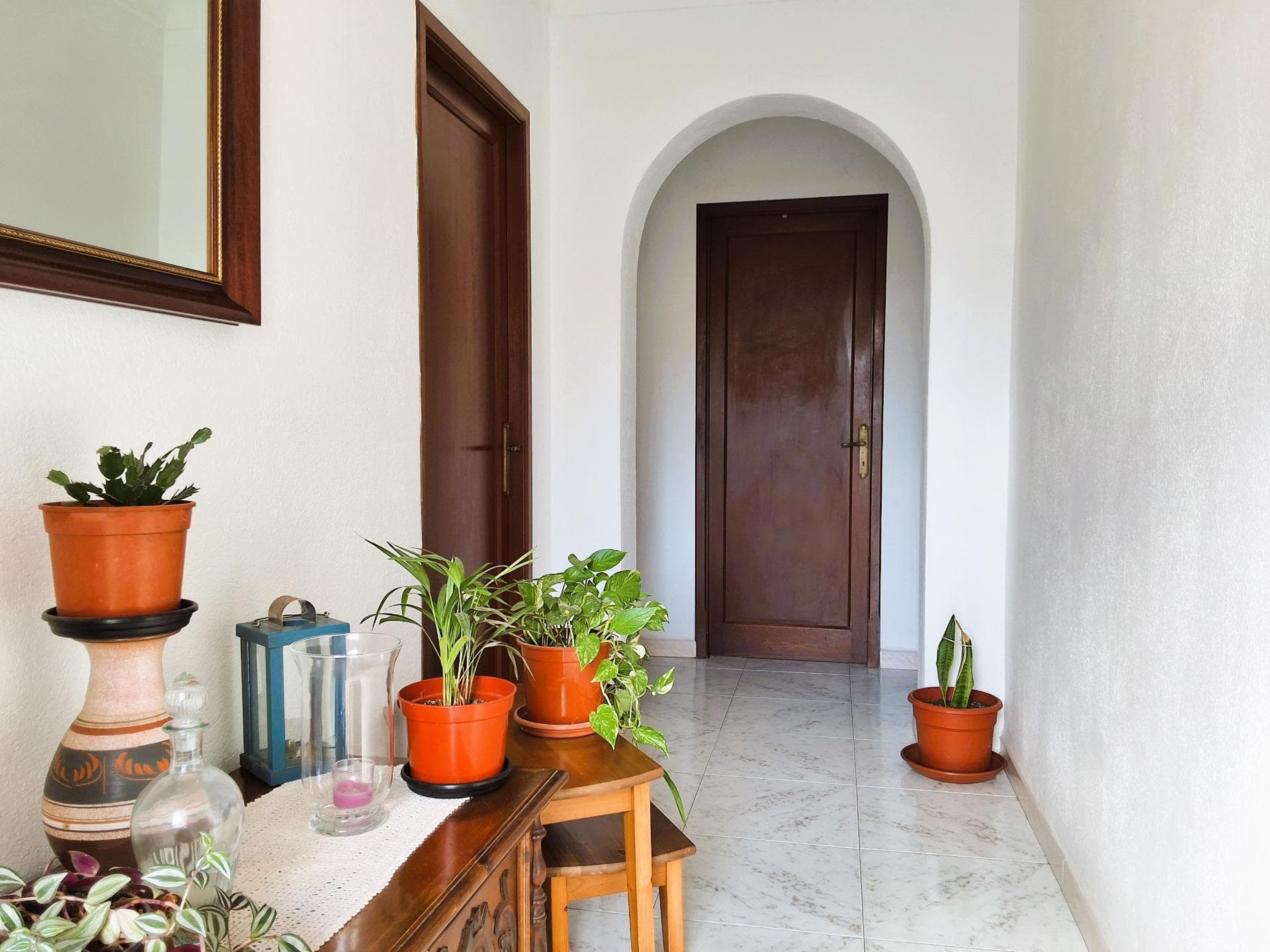 Charming ground floor house with a private garden, located in one of the quietest areas of Capdepera, perfect for those seeking comfort, functionality, and authentic Mallorcan charm. Designed on a single level, this home is ideal for a practical and hassle-free daily life.. Upon entering, a warm hallway leads us to the spacious and bright living-dining room, with unobstructed views of the street. This area, filled with natural light, offers a welcoming and family-friendly atmosphere, ideal for gatherings and relaxation.. The property features two spacious double bedrooms, both equipped with built-in wardrobes and large windows that fill the rooms with natural light. The bathroom is independent and includes a practical shower tray for added convenience.. The kitchen, fully equipped with quality furniture and appliances, stands out for its spaciousness and functionality. It also includes a pantry for additional storage. From the kitchen, you can access a spectacular backyard, a unique space that combines a charming garden with fruit trees, a functioning well, and a spacious, versatile laundry area.. In the patio, there is also a separate room, perfect for family gatherings or social events. This space features a fireplace that makes it cozy in both winter and summer and is also equipped with appliances for added comfort.. On the upper floor, the house offers a large terrace with views of the rooftops of the picturesque village of Capdepera. This space is perfect as a solarium or an outdoor relaxation area to enjoy the sun and Mallorca's pleasant weather.. The house has been built with traditional materials that give it character and authenticity. The tiled floors and wooden carpentry with fine glass add a rustic touch that blends perfectly with modern conveniences. Hot water is supplied by a butane water heater located in the laundry area.. Additionally, this house offers significant expansion potential. There is the possibility of building two additional rooms on the upper floor, increasing the property's value and versatility.. Although the house does not have a heating system, its excellent orientation ensures pleasant temperatures and abundant natural light throughout the year.. Strategically located, it is surrounded by all amenities: schools, high schools, supermarkets, bus stops, theaters, shops, golf courses, and just a few minutes from the fabulous beaches of Cala Ratjada, Font de Sa Cala, and Cala Mesquida. All this in one of the most beautiful and medieval villages in Mallorca, with its tranquil and picturesque atmosphere.. Don't miss this opportunity to acquire a unique house full of character and endless possibilities. Contact us for more information or to arrange a viewing.. Important: Purchase taxes, notary, and land registry fees are not included in the price. Additionally, as builders, we offer comprehensive advice for any renovation or customization you wish to undertake.