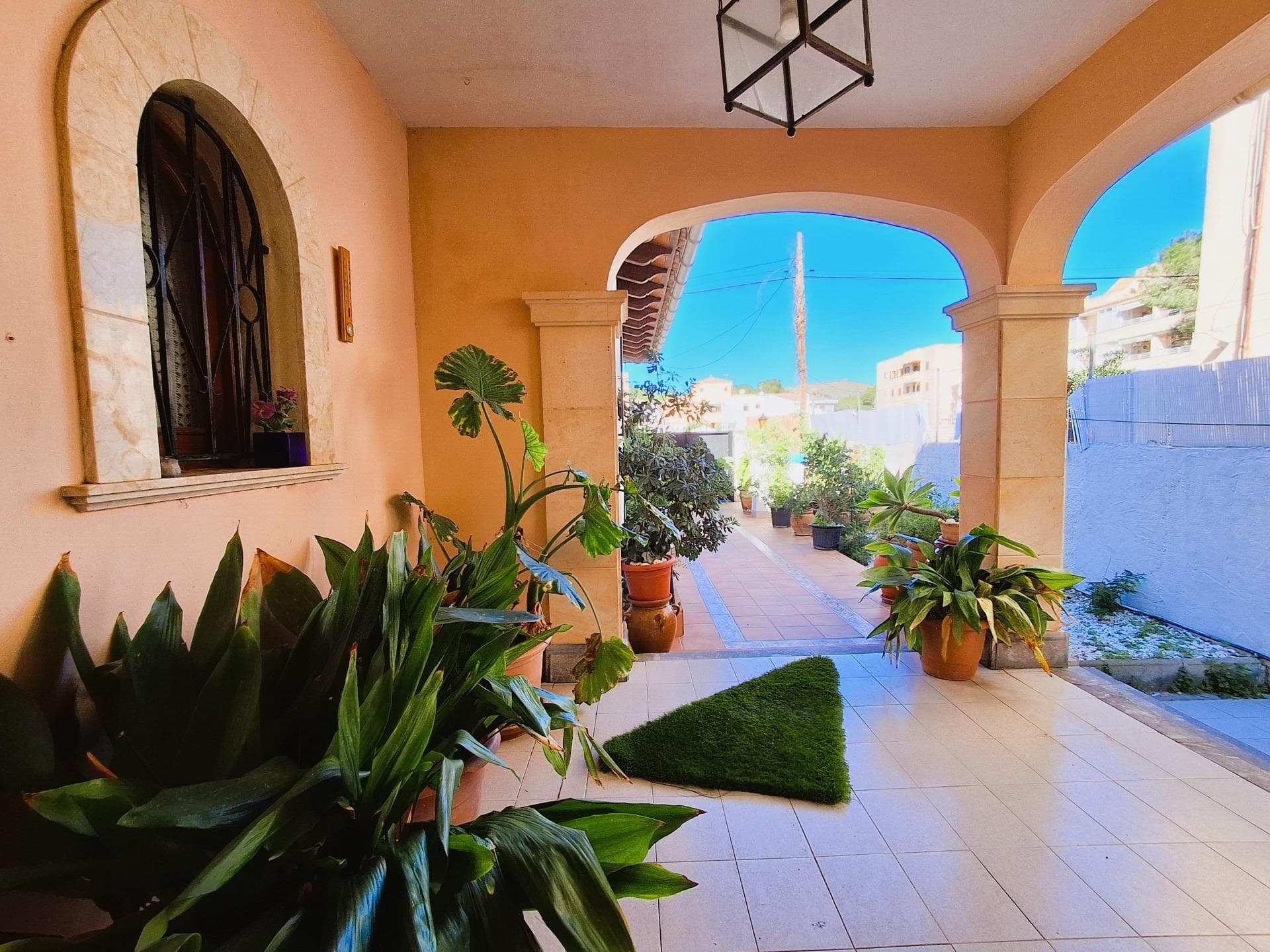 Let yourself be captivated by this fabulous property in Cala Ratjada. Cala Ratjada is a charming coastal town in the northeast of Mallorca, known for its natural beauty and vibrant Mediterranean atmosphere. It boasts spectacular beaches with crystal-clear waters such as Cala Agulla and Son Moll. The promenade, lined with bars, restaurants, and shops, creates a lively and inviting atmosphere.. The property is a spacious villa that combines comfort, elegance, and a privileged location. Its impressive terrace with a pool, perfect for sunny days, becomes a natural solarium where you can relax and unwind.. The ground floor houses the main residence, designed to maximize comfort and functionality. Upon entering, a spacious foyer welcomes you into light-filled spaces. The separate kitchen, fully equipped with wooden furniture and appliances, stands out for its spaciousness and brightness. It has direct access to a cozy living room and a fabulous dining room with a fireplace, adding a warm and elegant touch to the property.. This floor also features a large laundry room with cabinets for additional storage, two fully equipped bathrooms, and two spacious double bedrooms. One of them includes a walk-in closet and a marble en-suite bathroom, and both have direct access to the pool, ensuring maximum comfort.. On the same floor, there is an independent apartment with three double bedrooms, one bathroom, and an open-plan living and dining area with an integrated kitchen. Every corner has been thoughtfully designed to take advantage of oil heating and the high-quality wood and fine glass finishes. Built-in wardrobes and generous bathrooms with bathtubs complete the space. A charming porch overlooking the garden and pool adds a special touch, inviting you to enjoy it year-round.. The first floor, accessible via an exterior staircase and completely independent, offers an ideal layout for hosting guests or generating additional income. Here, you'll find two spacious bedrooms, a complete bathroom, a living-dining room with an integrated kitchen, and two large terraces where you can enjoy the fresh air and open views.. The most attractive feature of this property is its potential for profitability as an investment, with horizontal division. Additionally, its location is unbeatable: in a quiet area yet close to all essential amenities, such as schools, supermarkets, hotels, bars, libraries, beaches, and public transportation, including bus and taxi stops.. Don't miss this unique opportunity to live in a privileged environment with all the comfort and luxury you deserve. This villa in Cala Ratjada is much more than a house; it's a lifestyle experience you won't want to miss.. Important: Purchase taxes, notary, and land registry fees are not included in the price. Additionally, as developers, we offer comprehensive advice for any renovation or customization you wish to carry out.