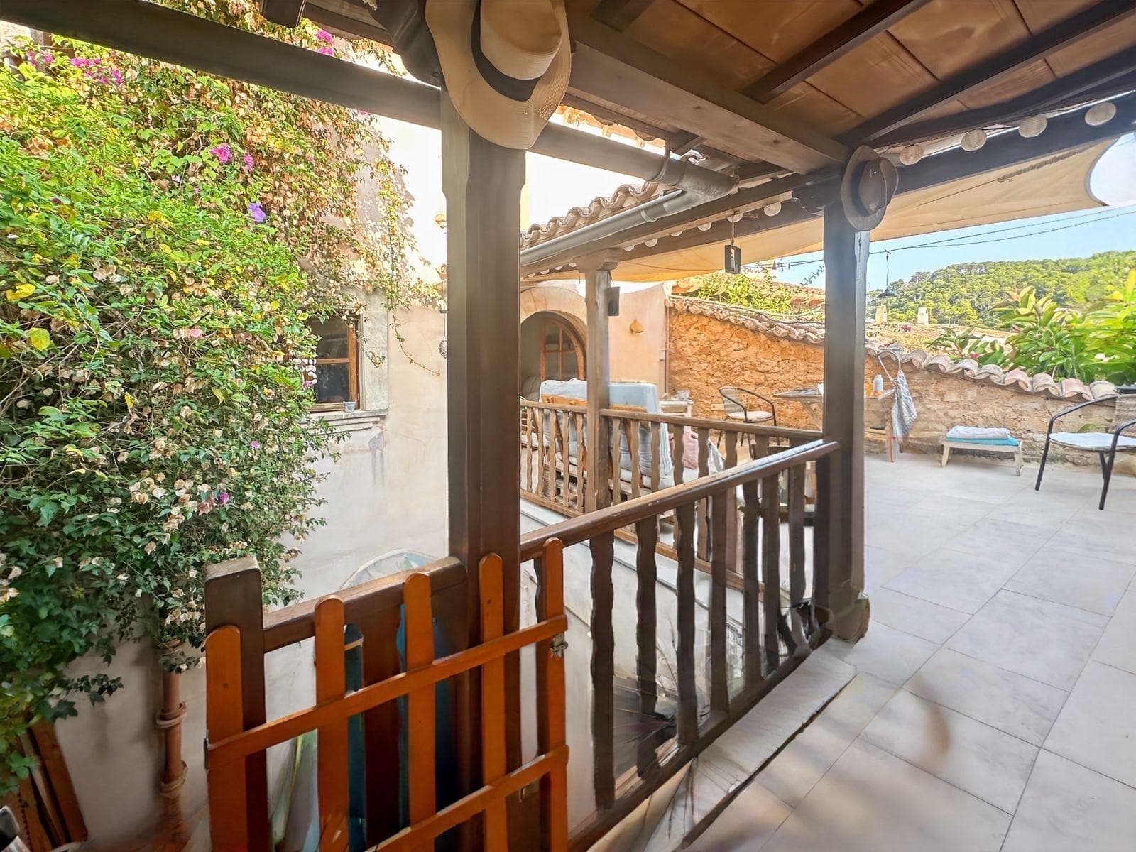 Charming semi-renovated townhouse in the heart of Capdepera’s old town.. Located on one of the most picturesque and iconic streets of Capdepera’s historic centre, next to the famous castle, this 19th-century townhouse has been carefully restored to preserve all its original Mallorcan charm while offering modern comfort and functionality.. The property has a built area of approximately 104 m² distributed over three levels, including a delightful inner courtyard filled with light and greenery – perfect for enjoying pleasant moments outdoors.. On the main floor, the living-dining area with open kitchen provides a warm and bright atmosphere with direct access to the terrace.. The upper floor features an open-plan space ideal as an office, reading corner or multipurpose room, as well as a master bedroom with en-suite bathroom.. The lower floor includes another full bathroom, a second bedroom, and an additional living room with independent access from the street, offering versatility and privacy.. The house retains its original architectural details such as exposed stone walls, wooden beams and traditional floors, combined with a tasteful and high-quality renovation.. Thanks to its privileged location on a quiet, cobbled and central street, just a few minutes from all amenities, this property is ideal as a permanent residence or a holiday retreat.. Important: The price does not include the taxes related to the property purchase, nor the notary and land registry fees.. We are a construction company, so if you need advice on renovations, extensions or any type of project, we will be happy to assist you.