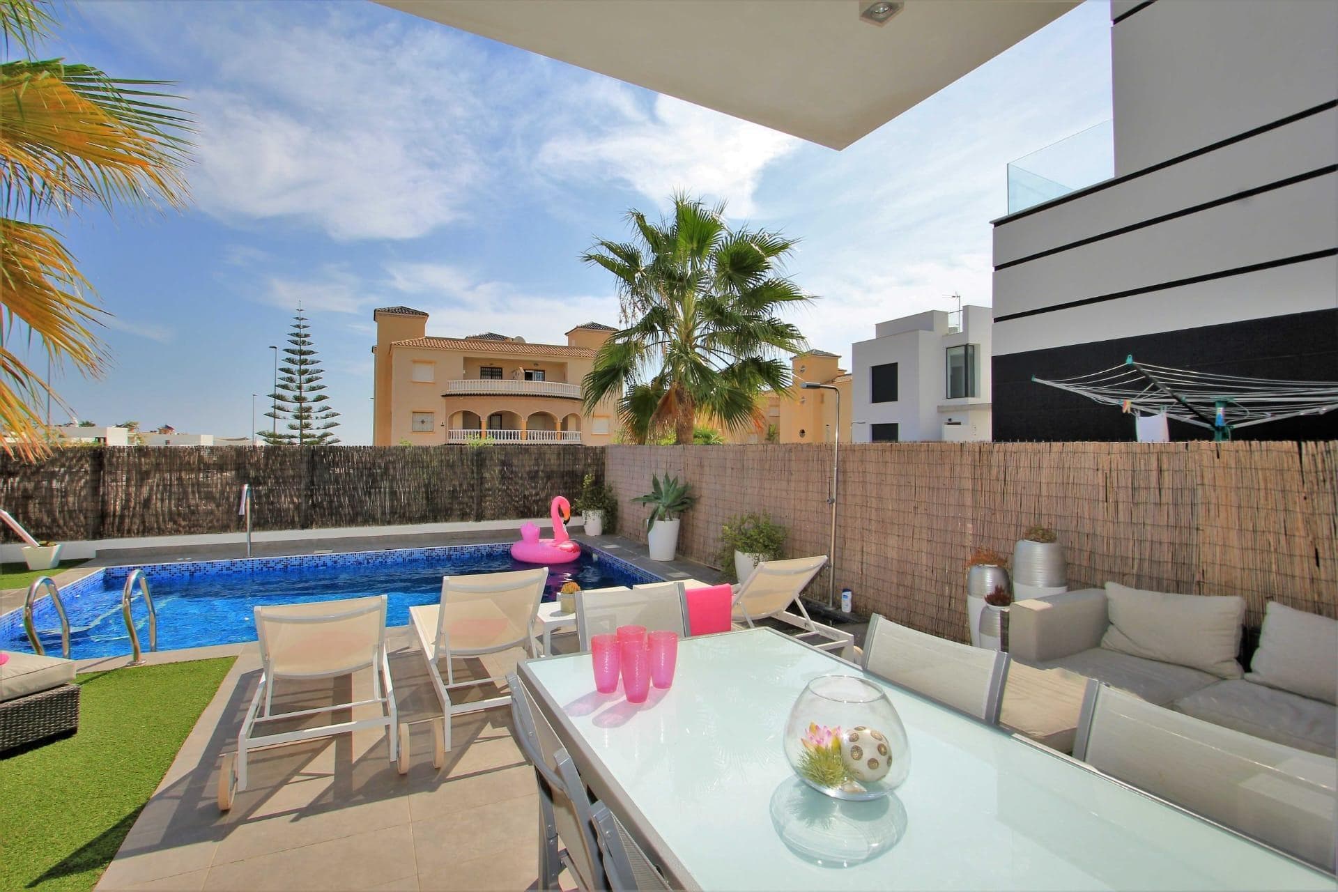 Discover the splendor of this stunning luxury villa available for year-round rental in the exclusive area of Lomas del Cabo Roig, Orihuela Costa. With a generous built area of 130 m² and situated on a spacious private plot of 340 m², this nearly new property offers three double bedrooms and three luxurious bathrooms that combine elegance with functionality. The equipped kitchen features modern finishes and includes details such as lacquered aluminum interior carpentry. Its southwest orientation ensures abundant natural light throughout the day, further enhancing the high ceilings that provide an unforgettable spacious feeling. This wonderful residence is completed with exceptional features: central air conditioning for both cool and heat, spacious fitted wardrobes, and bright balconies where you can enjoy the gentle Mediterranean breezes while taking in unobstructed views of the sea. A beautiful garden surrounds the home, offering absolute privacy; you will also have your own private pool, ideal for relaxing in the sun or enjoying memorable moments with friends by your outdoor barbecue. Strategically located close to prestigious universities, recognized schools, as well as vibrant shopping centers and charming family parks —life here is synonymous with not only comfort but also convenience—. All this enhanced by nearby facilities such as specialized local hospitals making this home truly attractive for both investment or personal enjoyment.