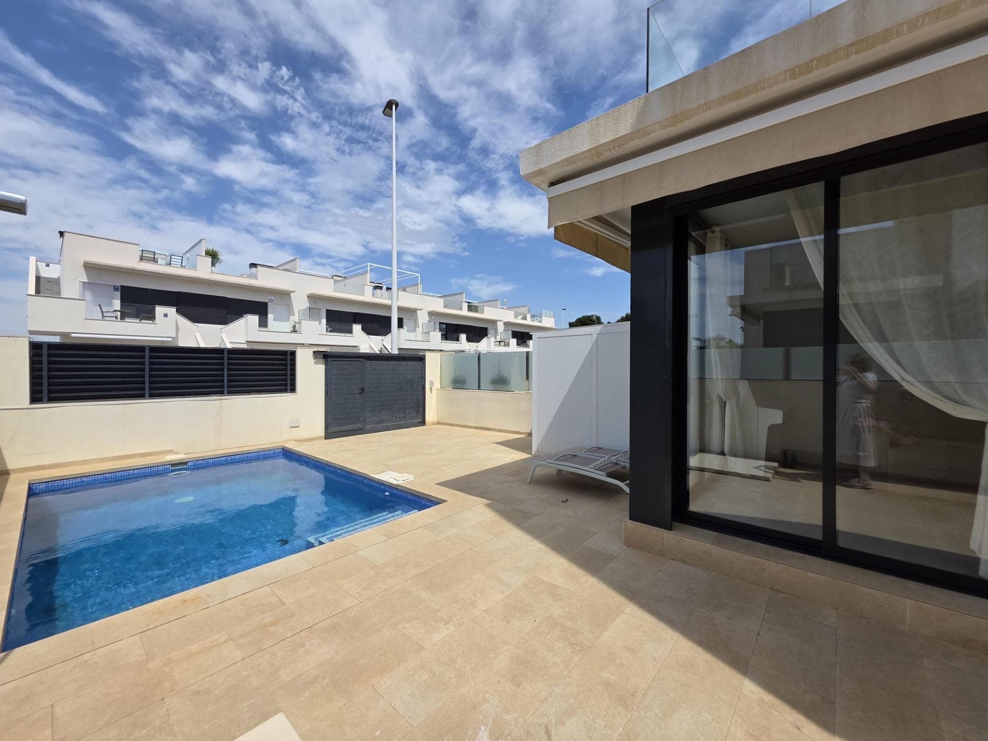 Welcome to this spectacular semi-detached villa, fully furnished and with a tourist license, that redefines the concept of luxury and comfort in San Pedro del Pinatar. With rental available under the option to buy through an initial payment of 25% of the total price, this property is strategically located just 800 meters from the stunning local beaches. Enjoy its spacious interiors covering a generous area of 125 m² along with a lush private plot of 169 m². The layout includes two elegant double bedrooms plus one cozy single room, all complemented by three contemporary bathrooms perfectly equipped for your comfort. The kitchen does not disappoint: fully equipped with modern appliances and impressive finishes such as white lacquered carpentry that floods every corner with natural light; acrylic floors add that elegant touch while external windows ensure optimal thermal insulation thanks to aluminum/climalit. Its exterior invites absolute relaxation: imagine enjoying unforgettable moments on the terrace facing your own private pool or sharing pleasant family days around the communal pool surrounded by clear views from the solarium equipped with shower for refreshing after sunbathing. This chalet is packed with extras designed exclusively to elevate your quality of life: cold/heat air conditioning ensures perfect temperature year-round; installed alarm provides additional security; as well as included private garage plus extra parking available! Every space has been meticulously designed—from built-in wardrobes to high ceilings—creating bright environments full style modern perfect families current given proximity schools hospitals commercial areas easily accessible where fun will be assured nearby playgrounds! Make an appointment today!. This property is undoubtedly best living near beach.