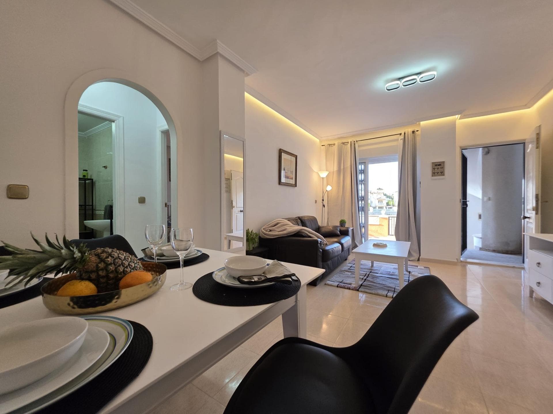 Discover your new home in the charming city of Orihuela Costa, specifically in the desired area of Lomas de Cabo Roig-Los Dolses. This spectacular ground floor apartment has been completely refurbished and offers a modern and cozy space that meets your needs. With a total built area of 72 m², it features two spacious double bedrooms perfect for resting after a long day. Relax in its bright living room, where you will enjoy unforgettable moments with family and friends thanks to its generous open spaces. But that’s not all; this wonderful property also has two terraces ideal for enjoying the Mediterranean climate while taking in stunning views of the surrounding nature. The main terrace is incredibly spacious (32 m²), perfect for outdoor gatherings or simply relaxing under the sun. Additionally, you can cool off during warm summer days thanks to the community facilities that include a swimming pool surrounded by landscaped areas filled with fruit trees that provide natural shade. Security is guaranteed with a reinforced door while every outdoor corner ensures unmatched freshness and natural light, further highlighting the charm of the place—all within a calming urbanization ideal for both a primary residence or vacation property. Living here means experiencing maximum tranquility as well as being an active part of the beautiful local environment full of recreational activities! Don’t miss this unique opportunity: come today! Your new life begins here.