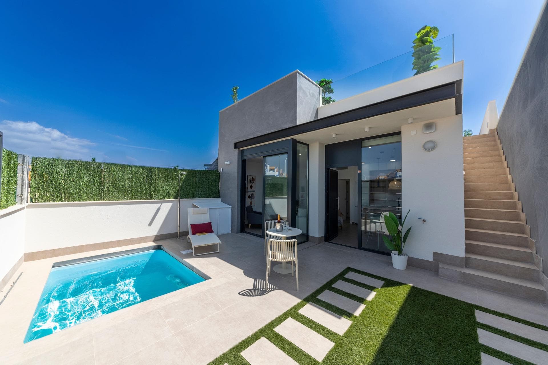 NEW BUILD VILLAS SAN JUAN DE LOS TERREROS, ALMERIA &#13;&#13;26 New Build Modern ground floor villas with solarium and private swimming pool, 2 and 3 bedrooms, 500 metres from the beaches.&#13;&#13;In the very heart, great access to all day to day services, such as restaurants, bars with exquisite gastronomy, educational centres, sports facilities, supermarkets, shops and shopping centre 10 min away by car.&#13;&#13;Villas located 60 min from Corvera International Airport and 60 min from Almeria International Airport.&#13;&#13;The project is going to be developed on an elevated plot where you will enjoy breathtaking views of green areas, located only 500 metres from the beach, close to very attractive tourist attractions such as our Geode, covered by huge crystals of selenite, a transparent or translucent variety of gypsum, the largest in the world that can be visited.&#13;&#13;Golf courses: Aguilón Golf at 5′ drive from the development and Golf San Juan at 3′ drive.&#13;&#13;Included in the price:&#13;Private swimming pool with lighting and outside shower.&#13;Solarium equipped with summer kitchen.&#13;Landscaped garden area with artificial grass and tiled as per plan.&#13;Utility room under the staircase with access to solarium.&#13;Interior and exterior LED lighting.&#13;TV points in all rooms and porch.&#13;Electric blinds in bedrooms.&#13;Entry phone.&#13;Sanitary fittings, mirror with LED and fixed screen.&#13;Fitted wardrobes finished with drawers and mezzanine.&#13;Fitted kitchen with Silestone worktop and front, electrical appliances (washing machine, oven, ceramic hob, extractor hood, dishwasher, fridge and aerothermal heater).&#13;The sliding windows are high security, double chamber.&#13;Pre-installation of AC ducts with return grilles.&#13;Pre-installation of photovoltaic panels.&#13;Parking space with artificial lawn and parking area inside the plot.&#13;Pre-installation for parking door motor.&#13;Perimeter wall with simple torsion fence and artificial hedge.&#13;City gas.&#13;&#13;San Juan de los Terreros, in Andalusia, is a dreamy coastal destination. Its crystal-clear waters invite you to relax under the sun and enjoy the tranquillity of the sea.&#13;&#13;The lifestyle in this charming town is calm and relaxed, with a slow pace that allows you to appreciate the natural beauty and rich culture of the region.&#13;&#13;With a wide range of restaurants, bars, and outdoor activities, San Juan de los Terreros is the perfect place to enjoy life by the sea.&#13;