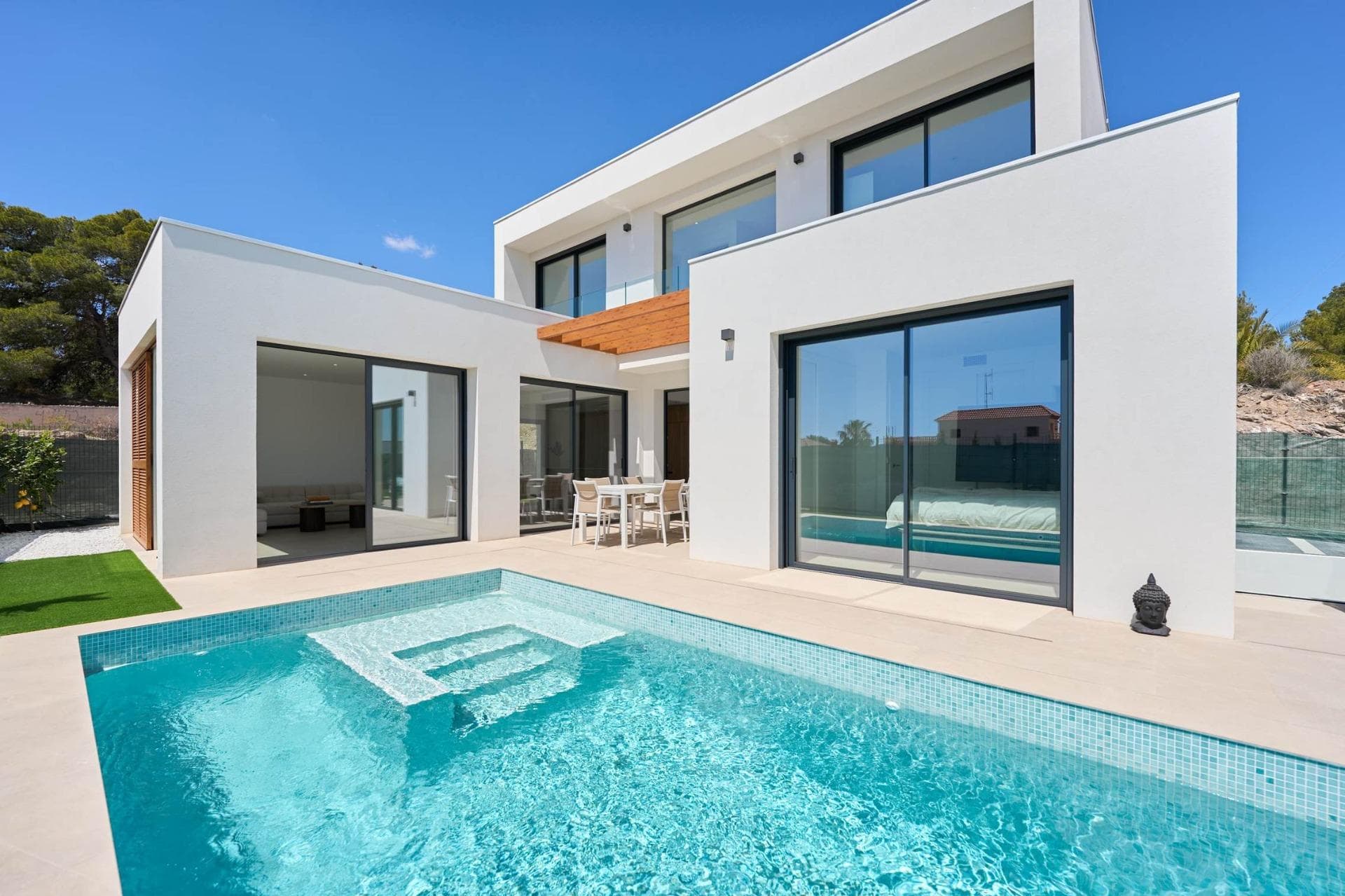 NEW BUILD VILLAS IN ALFAZ DEL PI&#13;&#13;New Build private urbanization of 12 villas with their own swimming pool and garden, located in one of the most exclusive areas of the Costa Blanca, Alfaz del Pí. &#13;&#13;New Build exclusive development that offers you a unique, familiar and natural environment in a privileged area close to all the necessary services to offer you tranquility and wellbeing. &#13;The unique design of its wooden structure, with straight, Mediterranean lines, gives it the warmth and harmony needed to make you feel part of nature while optimizing resources, making the villas more sustainable and efficient spaces.&#13;&#13;One of our guidelines when creating our development was the integration of our villas in nature, taking into account the surrounding green area, with the intention of increasing your quality of life and maximizing the positive influence on it.&#13;&#13;Houses designed taking into account the smallest details, its wooden shell, its bioclimatic pergola, the solar panel system and the efficient and stylish mallorquinas offer you the most exclusive option for sustainable housing.&#13;&#13;Open spaces full of light, great amplitude and no visual barriers, providing a sensation of infinite space. Large windows with direct access to the pool and garden area. The spacious living room with open kitchen makes it the ideal place to share with family and friends.&#13;&#13;High-quality kitchen units with porcelain worktops and highly energy-efficient appliances.&#13;&#13;Designed with the aim of providing the maximum harmony and balance necessary for a perfect recovery of both body and mind. With large floor-to-ceiling windows, the master bedroom has direct access to the swimming pool and garden area, which provide the extra comfort and relaxation so necessary for good rest.&#13;&#13;The bedrooms on the upper floor of the villa have been designed to maximize the astonishing views of the Mediterranean Sea and the beautiful Sierra Helada.&#13;&#13;Designed to create refuge spaces. The natural and warm tones are &#13;the protagonists, providing a sense of purity in the environment, &#13;optimising moments of enjoyment and relaxation and disconnection from the outside world. The Italian shower, the taps with water consumption reduction system, the furniture with built-in washbasins and the suspended sanitaryware make up a functional space positioning us at the forefront of the sector. &#13;&#13;Unique and innovative project based on minimum environmental &#13;impact promoting lower CO2 emissions in its construction, minimum energy consumption and a more sustainable and efficient use of resources.&#13;Project takes an important step towards environmental awareness. The wood used in the whole shell of our villas comes from forests whose logging is authorized and ensures reforestation, sustainability and protection of biodiversity. The use of this material in the construction of your new home brings with it a series of advantages that have a direct impact on both your wellbeing and the construction quality.&#13;&#13;Our homes are highly energy efficient, offering greater thermal and &#13;acoustic insulation, while maintaining the quality of the air inside the house and providing ideal natural lighting. The materials used in their construction are of high quality, durable and resistant to fire and humidity. &#13;&#13;Homes development is located in the well-known Scandinavia area of Alfáz del Pi. Just a few kilometers away lies the beach of Albir, where its crystal clear waters and the Sierra Helada with endless routes and activities makes it considered one of the best areas of the Costa Blanca. &#13;Very close to the Villas the urban center of Alfaz del Pí is situated, which meets all the necessary requirements for your new home, such as the extraordinary climate, with more than 300 days of sunshine a year, its gastronomic offer, the quality of its services and the magnificent relationship with the environment. &#13;There are also two prestigious Norwegian Schools as well as a Scandinavian club that already exists for half a century.&#13;