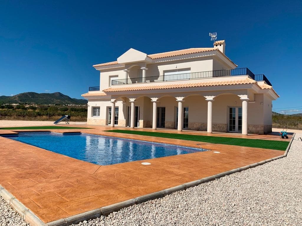 NEW BUILD VILLAS IN PINOSO&#13;&#13;You can choose Villas with traditional Spanish touches or super modern finishing, bright and clean. &#13;Different legal building plots available (rustic with minimum 10.000 m2), some walking distance to town, some totally private and our most popular ones are within 5-10 mins drive to a town. &#13;We have a plot for every taste, all with amazing views and all have mains water + electric included in the price and high speed internet available. &#13;From the biggest and best builder in the area and use top quality materials for a perfect finish. &#13;All houses include 2m stamped concrete terrace around the pool (colour and pattern to choose), 1m around the house, gated entrance, 3.000 m2 fencing, pre-installed ducted aircon, standard kitchen, security door, german tilt and turn windows (or sliding if prefered), built-in fireplace and chimney, pre-installation for tv and internet, gravel driveway plus a few meters around the house, septic tank. &#13;Bathrooms include a shower column, shower tray or bath, sink units (various colours to choose from) with sinks, taps and mirrors, plus a big selection of wall tiles. &#13;Wide selection of ceramic floor tiles, different colours, wood effect, etc. &#13;Kitchens include cabinets with standard doors and handles, as per plans provided, stainless steel sink and tap, pre-installation for oven, dishwasher, extractor. Various granite worktops to choose from included in the budget, other stone worktops available as extras. White goods not included. &#13;Marble staircase (cream, white, or grey) and railings included, plus railings for the front porch. &#13;Big fixed glass window on the staircase for extra light. &#13;Choice of tiles and steps design for swimming pool. Choice of the granite for the houses' exterior steps and window sils. &#13;You can customise the house to suit, most internal changes are free of charge, the houses can be extended and we can even build your own design. &#13;Upgrade to bigger pool, single or double garage, guest house, etc. at an extra cost.&#13;&#13;The beautiful and thriving town of Pinoso is approximately 45 minutes inland from Alicante and the white beaches of Costa Blanca and close to the Murcia, Alicante border&#13;&#13;It has a population of just under 8,000. Pinoso, also known as El Pinos is named after the pine trees that cover the areas mountain ranges. Pinoso provides a Spanish rural lifestyle, no traffic lights, hardly any traffic, practically the only jams are caused by the tractors taking the grapes to the Bodega. The fields are planted with vines, almonds and olives. In February the fields are filled with pink almond blossom.&#13;&#13;Pinoso has many bars, restaurants and shops, a new 24 hour medical centre, dentists, two primary schools and 1 secondary school, a theatre. There's an excellent Sports Centre with outdoor swimming pools, tennis courts, football pitches and gymnasium, library and many other facilities including a beautiful picnic area among the pines, complete with barbecues, seating areas and running water.&#13;