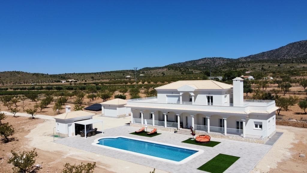 NEW BUILD VILLAS IN PINOSO&#13;&#13;You can choose Villas with traditional Spanish touches or super modern finishing, bright and clean. &#13;Different legal building plots available (rustic with minimum 10.000 m2), some walking distance to town, some totally private and our most popular ones are within 5-10 mins drive to a town. &#13;We have a plot for every taste, all with amazing views and all have mains water + electric included in the price and high speed internet available. &#13;From the biggest and best builder in the area and use top quality materials for a perfect finish. &#13;All houses include 2m stamped concrete terrace around the pool (colour and pattern to choose), 1m around the house, gated entrance, 3.000 m2 fencing, pre-installed ducted aircon, standard kitchen, security door, german tilt and turn windows (or sliding if prefered), built-in fireplace and chimney, pre-installation for tv and internet, gravel driveway plus a few meters around the house, septic tank. &#13;Bathrooms include a shower column, shower tray or bath, sink units (various colours to choose from) with sinks, taps and mirrors, plus a big selection of wall tiles. &#13;Wide selection of ceramic floor tiles, different colours, wood effect, etc. &#13;Kitchens include cabinets with standard doors and handles, as per plans provided, stainless steel sink and tap, pre-installation for oven, dishwasher, extractor. Various granite worktops to choose from included in the budget, other stone worktops available as extras. White goods not included. &#13;Marble staircase (cream, white, or grey) and railings included, plus railings for the front porch. &#13;Big fixed glass window on the staircase for extra light. &#13;Choice of tiles and steps design for swimming pool. Choice of the granite for the houses' exterior steps and window sils. &#13;You can customise the house to suit, most internal changes are free of charge, the houses can be extended and we can even build your own design. &#13;Upgrade to bigger pool, single or double garage, guest house, etc. at an extra cost.&#13;&#13;The beautiful and thriving town of Pinoso is approximately 45 minutes inland from Alicante and the white beaches of Costa Blanca and close to the Murcia, Alicante border&#13;&#13;It has a population of just under 8,000. Pinoso, also known as El Pinos is named after the pine trees that cover the areas mountain ranges. Pinoso provides a Spanish rural lifestyle, no traffic lights, hardly any traffic, practically the only jams are caused by the tractors taking the grapes to the Bodega. The fields are planted with vines, almonds and olives. In February the fields are filled with pink almond blossom.&#13;&#13;Pinoso has many bars, restaurants and shops, a new 24 hour medical centre, dentists, two primary schools and 1 secondary school, a theatre. There's an excellent Sports Centre with outdoor swimming pools, tennis courts, football pitches and gymnasium, library and many other facilities including a beautiful picnic area among the pines, complete with barbecues, seating areas and running water.&#13;