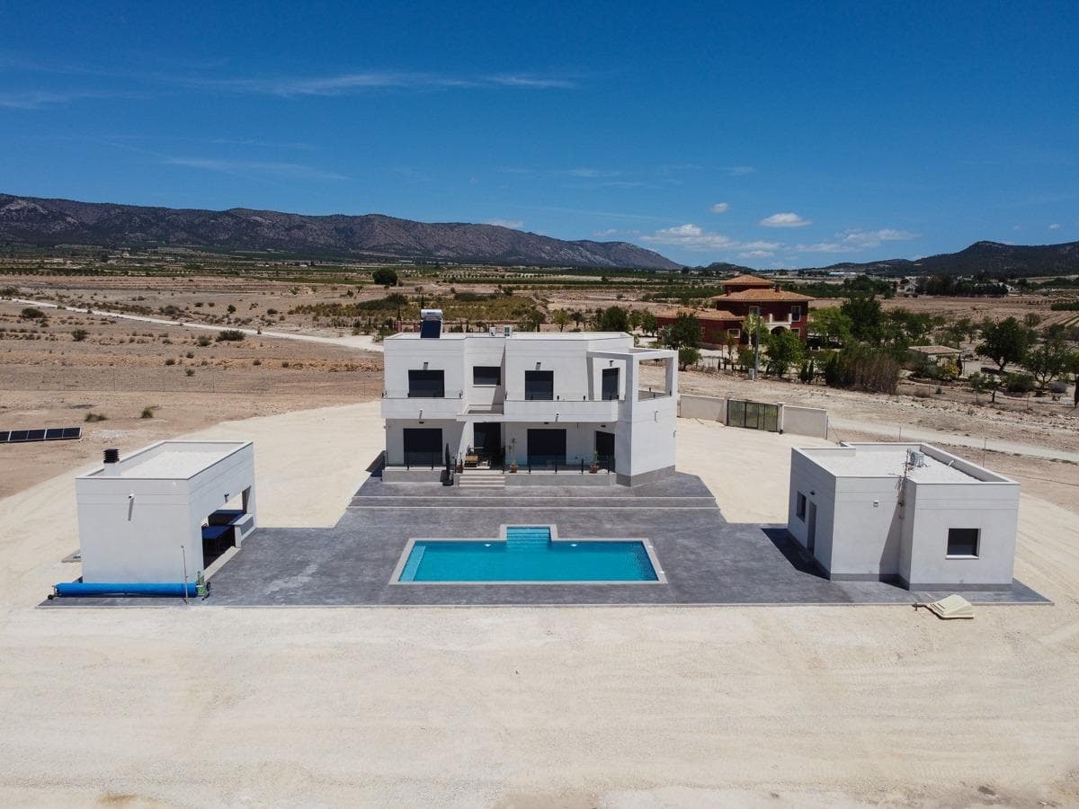 NEW BUILD VILLAS IN PINOSO&#13;&#13;You can choose Villas with traditional Spanish touches or super modern finishing, bright and clean. &#13;Different legal building plots available (rustic with minimum 10.000 m2), some walking distance to town, some totally private and our most popular ones are within 5-10 mins drive to a town. &#13;We have a plot for every taste, all with amazing views and all have mains water + electric included in the price and high speed internet available. &#13;From the biggest and best builder in the area and use top quality materials for a perfect finish. &#13;All houses include 2m stamped concrete terrace around the pool (colour and pattern to choose), 1m around the house, gated entrance, 3.000 m2 fencing, pre-installed ducted aircon, standard kitchen, security door, german tilt and turn windows (or sliding if prefered), built-in fireplace and chimney, pre-installation for tv and internet, gravel driveway plus a few meters around the house, septic tank. &#13;Bathrooms include a shower column, shower tray or bath, sink units (various colours to choose from) with sinks, taps and mirrors, plus a big selection of wall tiles. &#13;Wide selection of ceramic floor tiles, different colours, wood effect, etc. &#13;Kitchens include cabinets with standard doors and handles, as per plans provided, stainless steel sink and tap, pre-installation for oven, dishwasher, extractor. Various granite worktops to choose from included in the budget, other stone worktops available as extras. White goods not included. &#13;Marble staircase (cream, white, or grey) and railings included, plus railings for the front porch. &#13;Big fixed glass window on the staircase for extra light. &#13;Choice of tiles and steps design for swimming pool. Choice of the granite for the houses' exterior steps and window sils. &#13;You can customise the house to suit, most internal changes are free of charge, the houses can be extended and we can even build your own design. &#13;Upgrade to bigger pool, single or double garage, guest house, etc. at an extra cost.&#13;&#13;The beautiful and thriving town of Pinoso is approximately 45 minutes inland from Alicante and the white beaches of Costa Blanca and close to the Murcia, Alicante border&#13;&#13;It has a population of just under 8,000. Pinoso, also known as El Pinos is named after the pine trees that cover the areas mountain ranges. Pinoso provides a Spanish rural lifestyle, no traffic lights, hardly any traffic, practically the only jams are caused by the tractors taking the grapes to the Bodega. The fields are planted with vines, almonds and olives. In February the fields are filled with pink almond blossom.&#13;&#13;Pinoso has many bars, restaurants and shops, a new 24 hour medical centre, dentists, two primary schools and 1 secondary school, a theatre. There's an excellent Sports Centre with outdoor swimming pools, tennis courts, football pitches and gymnasium, library and many other facilities including a beautiful picnic area among the pines, complete with barbecues, seating areas and running water.&#13;