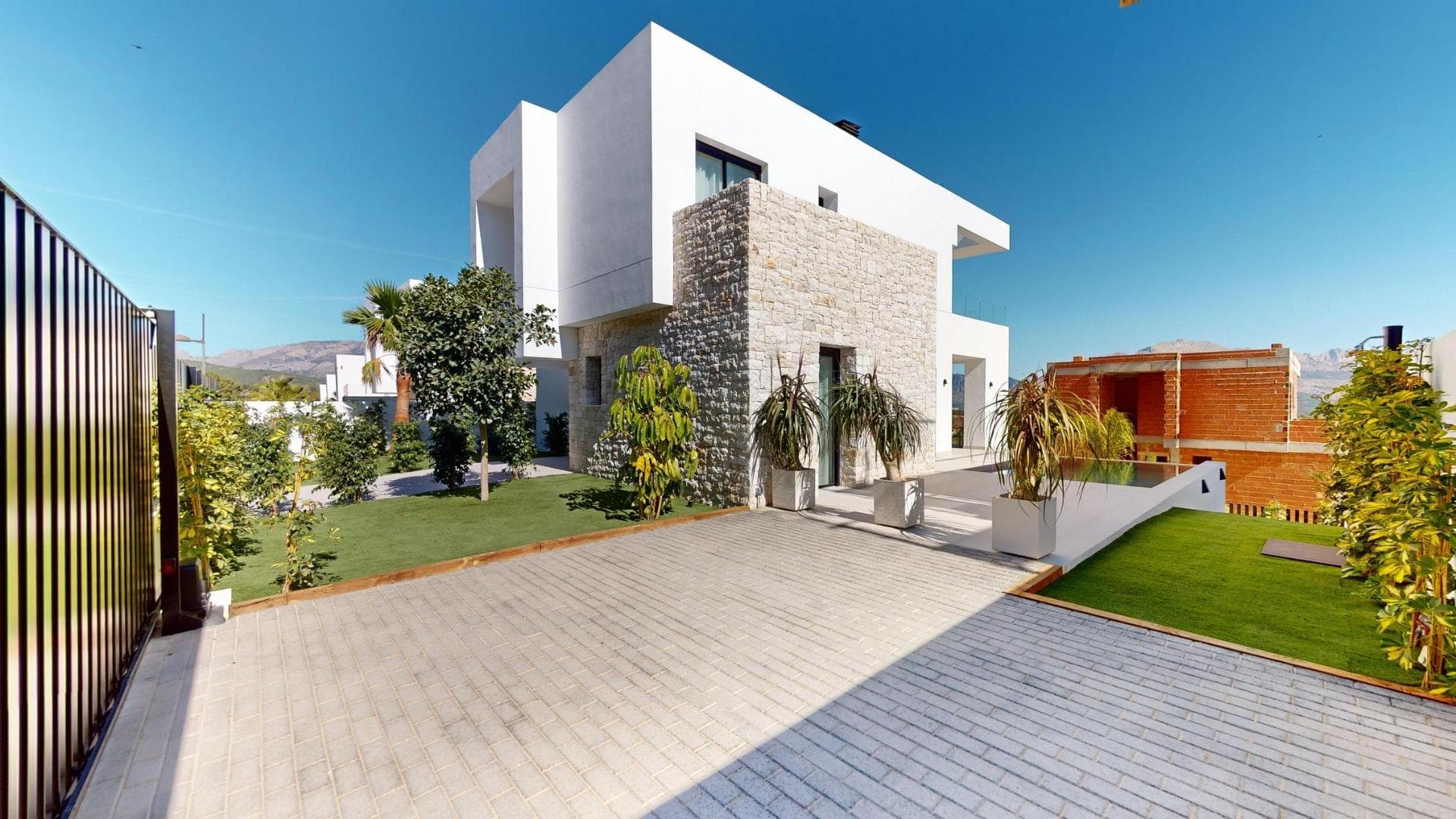 New Build Luxury Villas in Polop with Stunning Views&#13;Exclusive Development of 6 Luxury Villas in Polop&#13;&#13;This brand-new promotion of 6 luxury villas is located in Polop, offering breathtaking views of the sea and mountains. Each villa is built on an independent plot with a private swimming pool, parking, barbecue area, and a spacious garden. The villas are spread over two floors plus a semi-basement, with a total of 293 m² on private plots of 393 m².&#13;&#13;Spacious Layout and Modern Design&#13;On the main floor, you will find a modern kitchen with an island, an open-plan living and dining area, one bedroom, one bathroom, a covered terrace, and a large open terrace, perfect for enjoying the views of Polop, Altea, and the surrounding mountains. The first floor features two large bedrooms, two bathrooms, and two terraces, both covered and open. The semi-basement can be converted into an independent living space.&#13;&#13;High-Quality Finishes and Energy Efficiency&#13;The villas come with a fully equipped kitchen featuring Siemens appliances. Bathrooms are fully fitted with high-end Roca fixtures. Each home has underfloor heating, air conditioning, and an infinity pool. The villas are designed with energy efficiency in mind, boasting an energy certificate rating of A.&#13;&#13;Prime Location Close to Amenities&#13;Located just 10 km from Benidorm and Altea, these villas are only a short drive from La Nucía and Alfaz del Pi. The area offers easy access to major points of interest, including the beaches of Benidorm (15 km), Alicante Airport (65 km), and several golf courses (within 10 km). Polop’s proximity to these amenities, combined with its tranquil setting, makes it an ideal place for outdoor enthusiasts and those seeking peace.&#13;