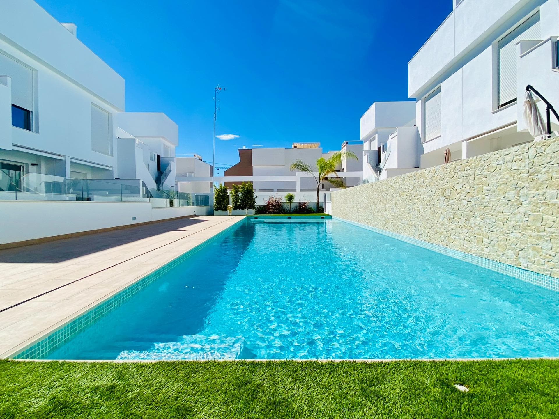New Build Bungalow Residential Complex in Pilar de la Horadada&#13;&#13;Exclusive Modern Bungalows in Pilar de la Horadada&#13;This new development offers 16 stylish bungalows in the desirable town of Pilar de la Horadada, located in the southernmost part of Costa Blanca. Choose between 2 or 3-bedroom options, each featuring 2 bathrooms. Ground-floor units come with spacious front and rear terraces, providing direct access to the communal pool and garden, while top-floor units boast a large private rooftop solarium.&#13;&#13;Spacious Living with Modern Features&#13;Each bungalow includes a bright and open living/dining area and a fully equipped kitchen with large sliding doors that connect the indoor and outdoor spaces seamlessly. Bedrooms feature built-in wardrobes. Ducted air conditioning is installed, and the complex includes an elevator for easy access to upper floors. Private parking spaces are also included for all units.&#13;&#13;Prime Location in Pilar de la Horadada&#13;Pilar de la Horadada is a traditional Spanish town with a lively main street offering supermarkets, shops, restaurants, and bars. The beautiful beaches of Torre de la Horadada and Mil Palmeras are just 5 minutes away. The development is conveniently located 40 km from Corvera Airport (Murcia) and 55 km from Alicante Airport, making it an ideal location for both permanent living and holiday getaways.&#13;