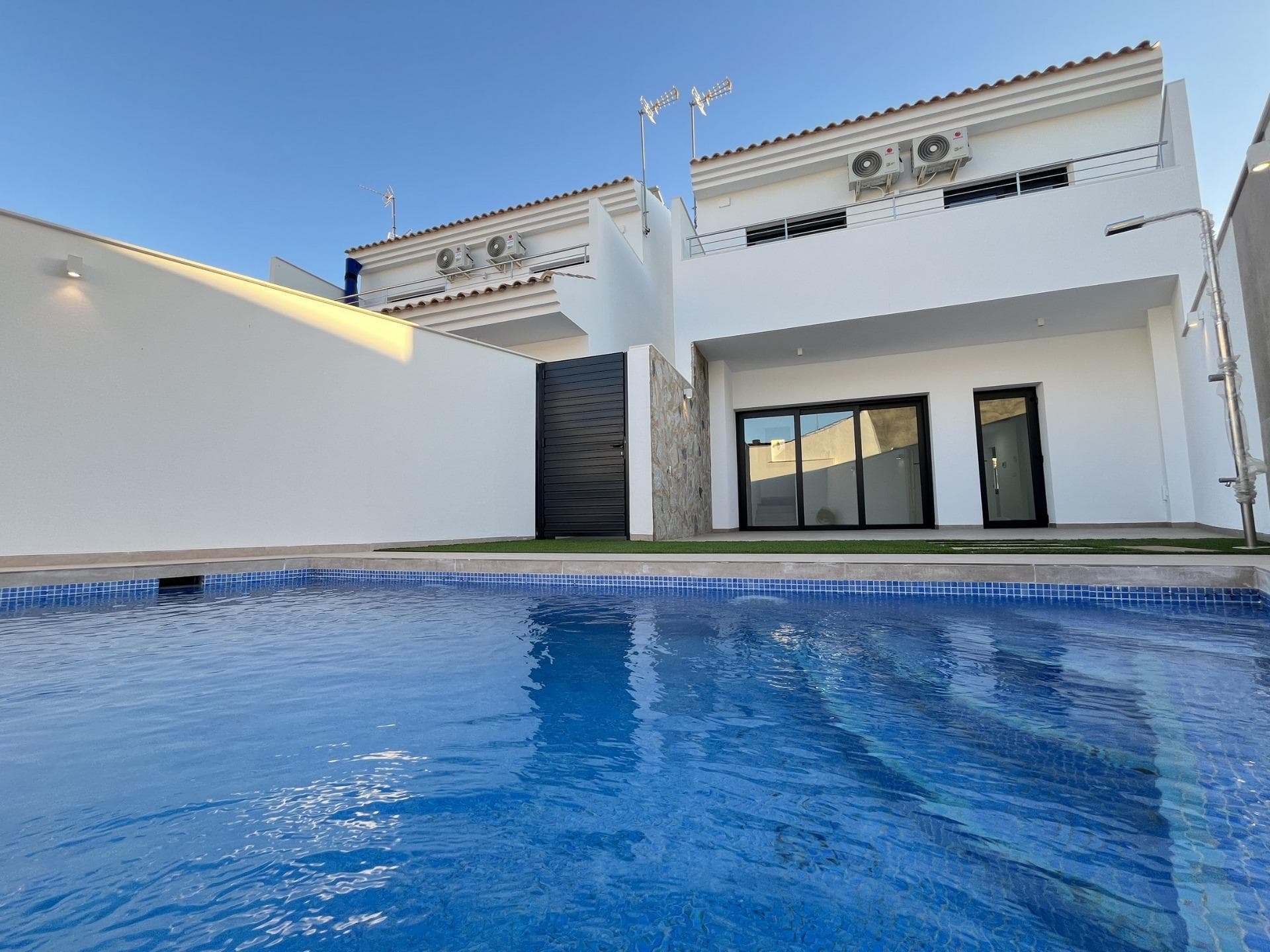 Key Ready New Build Villa with Private Pool Just 500m from Beach in San Pedro del Pinatar&#13;&#13;Exclusive New Build in Prime Costa Cálida Location&#13;Discover this exceptional new build villa in San Pedro del Pinatar, just 500 metres from the sandy shores of Villananitos Beach. This key ready property offers a perfect blend of modern design, luxury finishes, and unbeatable location on Spain’s sought-after Costa Cálida. Whether you're looking for a holiday home, a year-round residence, or a high-return investment, this villa delivers on all fronts.&#13;&#13;Spacious Layout with Modern Elegance&#13;Set on a 240 m² plot, this villa offers a constructed area of 145 m² distributed across two levels. It includes:&#13;&#13;Three spacious bedrooms, one of which is on the ground floor with an en-suite bathroom&#13;Two full bathrooms with walk-in showers and premium materials&#13;One guest toilet on the ground floor&#13;Open-plan kitchen with high-end Bosch appliances&#13;Large and bright living room with direct views to the pool terrace&#13;Four terraces ideal for outdoor living and entertaining&#13;&#13;Each space is designed for comfort, elegance, and functionality, with excellent insulation and ducted air conditioning for year-round climate control.&#13;&#13;Private Pool and Outdoor Living&#13;Enjoy Mediterranean living to the fullest with your own private swimming pool, outdoor shower, and multiple terraces for sunbathing, reading, or al fresco dining. Modern outdoor lighting enhances the ambiance, making it perfect for relaxing evenings under the stars.&#13;&#13;There’s also private parking within the plot and a large indoor utility room with connections for a washer, dryer, and an energy-efficient aerothermal system for hot water.&#13;&#13;Strategic Coastal Location&#13;Located in San Pedro del Pinatar, a charming town known for its authentic Spanish atmosphere and modern amenities:&#13;&#13;Villananitos Beach – 0.5 km&#13;Dos Mares Shopping Centre – 3 km&#13;Roda Golf Course – 7 km&#13;Lo Pagán Marina – 1.5 km&#13;Murcia city centre – 47 km&#13;Cartagena – 34 km&#13;&#13;This privileged location offers easy access to beaches, golf courses, shopping, dining, and key transport links, making it ideal for both leisure and everyday living.&#13;&#13;Don’t Miss This Turnkey Opportunity&#13;If you're dreaming of a stylish, move-in-ready home near the sea, this villa in San Pedro del Pinatar is the perfect choice.&#13;Contact us today to schedule a viewing or request more information.&#13;