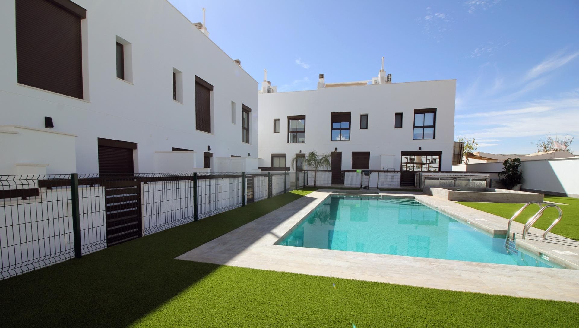 Modern Townhouses and Semi-Detached Homes in Pilar de la Horadada&#13;&#13;Discover this exclusive residential development featuring only six modern semi-detached and terraced homes in the tranquil town of Pilar de la Horadada, on the southern tip of the Costa Blanca. Designed with contemporary architecture and high-quality finishes, these new-build properties offer a perfect blend of comfort and style in a sought-after location.&#13;&#13;Spacious Three and Four Bedroom Layouts&#13;&#13;Each home boasts spacious living areas with an open-plan kitchen and living room designed to maximise natural light. Choose from three or four-bedroom floor plans, with two or three bathrooms depending on the model. Ground-floor layouts include two terraces: a front terrace with space for private parking and a rear terrace with direct access to the communal pool. The first floor features an additional terrace off the bedrooms, while upstairs a rooftop solarium provides panoramic views and an ideal space for outdoor entertaining.&#13;&#13;High-Quality Interior Finishes&#13;&#13;Interiors are appointed with premium materials, including smooth plaster walls, porcelain tile flooring throughout, and fitted wardrobes in each bedroom. The open kitchens come fully equipped with modern cabinetry. Additional comforts include pre-installation for ducted air conditioning and aerothermal systems for energy-efficient hot water.&#13;&#13;Community Amenities and Private Parking&#13;&#13;Residents enjoy a well-maintained communal pool, perfect for relaxation on sunny days. Each home includes a private on-plot parking space, ensuring security and convenience.&#13;&#13;Pilar de la Horadada: Traditional Charm on the Costa Blanca&#13;&#13;Pilar de la Horadada is a charming Spanish town known for its welcoming atmosphere and traditional architecture. The town centre is just a short walk away, where you will find supermarkets, local shops, restaurants, bars, and picturesque plazas. Enjoy a leisurely stroll along the main street, sampling authentic Mediterranean cuisine or exploring artisan boutiques.&#13;&#13;Proximity to Beaches and Airports&#13;&#13;Experience the best of coastal living with the fine sandy beaches of Torre de la Horadada and Mil Palmeras just a 5‑minute drive (approximately 2 km) from your new home. These beaches boast clear waters, golden sand, and a lively promenade lined with cafés and sea-view restaurants.&#13;&#13;For easy travel, Corvera Airport (Murcia) is approximately 40 km away (40 minutes by car), and Alicante Airport is around 55 km (55 minutes by car). Additionally, La Zenia Boulevard shopping centre is 15 km (15 minutes) from the development, offering a wide range of retail, dining, and entertainment options.&#13;&#13;Secure Your New Home Today&#13;&#13;Don’t miss this opportunity to own a brand-new semi-detached or terraced home in Pilar de la Horadada. Combining modern design, top-quality finishes, and a prime location near beaches, shops, and services, these properties are ideal as a permanent residence, holiday home, or investment. Contact us now for more information and to arrange a visit.&#13;