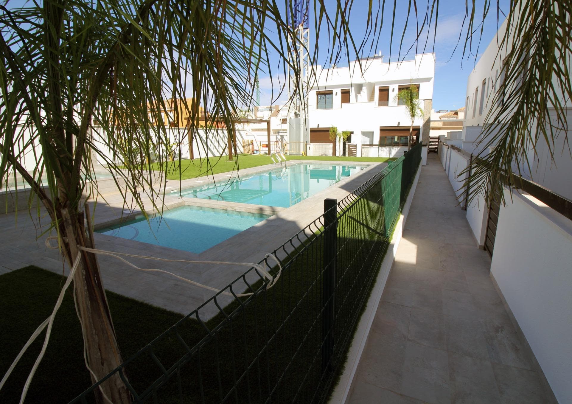 Modern Townhouses and Semi-Detached Homes in Pilar de la Horadada&#13;&#13;Discover this exclusive residential development featuring only six modern semi-detached and terraced homes in the tranquil town of Pilar de la Horadada, on the southern tip of the Costa Blanca. Designed with contemporary architecture and high-quality finishes, these new-build properties offer a perfect blend of comfort and style in a sought-after location.&#13;&#13;Spacious Three and Four Bedroom Layouts&#13;&#13;Each home boasts spacious living areas with an open-plan kitchen and living room designed to maximise natural light. Choose from three or four-bedroom floor plans, with two or three bathrooms depending on the model. Ground-floor layouts include two terraces: a front terrace with space for private parking and a rear terrace with direct access to the communal pool. The first floor features an additional terrace off the bedrooms, while upstairs a rooftop solarium provides panoramic views and an ideal space for outdoor entertaining.&#13;&#13;High-Quality Interior Finishes&#13;&#13;Interiors are appointed with premium materials, including smooth plaster walls, porcelain tile flooring throughout, and fitted wardrobes in each bedroom. The open kitchens come fully equipped with modern cabinetry. Additional comforts include pre-installation for ducted air conditioning and aerothermal systems for energy-efficient hot water.&#13;&#13;Community Amenities and Private Parking&#13;&#13;Residents enjoy a well-maintained communal pool, perfect for relaxation on sunny days. Each home includes a private on-plot parking space, ensuring security and convenience.&#13;&#13;Pilar de la Horadada: Traditional Charm on the Costa Blanca&#13;&#13;Pilar de la Horadada is a charming Spanish town known for its welcoming atmosphere and traditional architecture. The town centre is just a short walk away, where you will find supermarkets, local shops, restaurants, bars, and picturesque plazas. Enjoy a leisurely stroll along the main street, sampling authentic Mediterranean cuisine or exploring artisan boutiques.&#13;&#13;Proximity to Beaches and Airports&#13;&#13;Experience the best of coastal living with the fine sandy beaches of Torre de la Horadada and Mil Palmeras just a 5‑minute drive (approximately 2 km) from your new home. These beaches boast clear waters, golden sand, and a lively promenade lined with cafés and sea-view restaurants.&#13;&#13;For easy travel, Corvera Airport (Murcia) is approximately 40 km away (40 minutes by car), and Alicante Airport is around 55 km (55 minutes by car). Additionally, La Zenia Boulevard shopping centre is 15 km (15 minutes) from the development, offering a wide range of retail, dining, and entertainment options.&#13;&#13;Secure Your New Home Today&#13;&#13;Don’t miss this opportunity to own a brand-new semi-detached or terraced home in Pilar de la Horadada. Combining modern design, top-quality finishes, and a prime location near beaches, shops, and services, these properties are ideal as a permanent residence, holiday home, or investment. Contact us now for more information and to arrange a visit.&#13;
