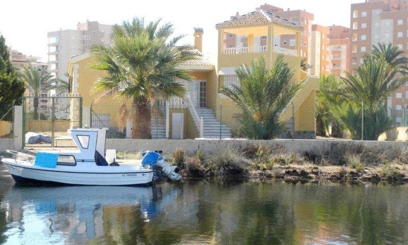 LUXURY VILLA WITH PRIVATE PIER&#13;&#13; Between two seas, the Mar Menor and the Mediterranean, is this beautiful luxury villa on the La Manga peninsula (Murcia), with one of the most privileged views in the area, (and being a few meters from the beach) This property has a private jetty (for a boat up to 12 m) that allows access to the sea through a system of wide channels.&#13;&#13; It is located in the Veneziola area, with immediate connections to the natural islets, the golf course and the marina. It is a new construction with high qualities and finishes typical of a luxury home.&#13;&#13; With a constructed area of ​​465.32m2 on a 1,361m2 plot, on the ground floor it has 3 very spacious double bedrooms and 2 bathrooms, a large living room with a fireplace, a separate dining room, a spacious independent hardwood kitchen and a large pantry. to store food, laundry etc. Large front and back porches. Enjoy 2 very spacious terraces and a 72m2 solarium with a viewpoint on top of the building with privileged panoramic views over the Mar Menor. The garden is finished for easy maintenance and has a Private Pool. Double glazed exterior carpentry and double closure. Built-in wardrobes in all bedrooms. Basement / garage of 239m2, ideal for the installation of gyms, warehouses, games room etc.&#13;&#13; Behind the building there is a private jetty that allows access to the sea through a system of channels. The beaches are a few meters from the house.&#13;