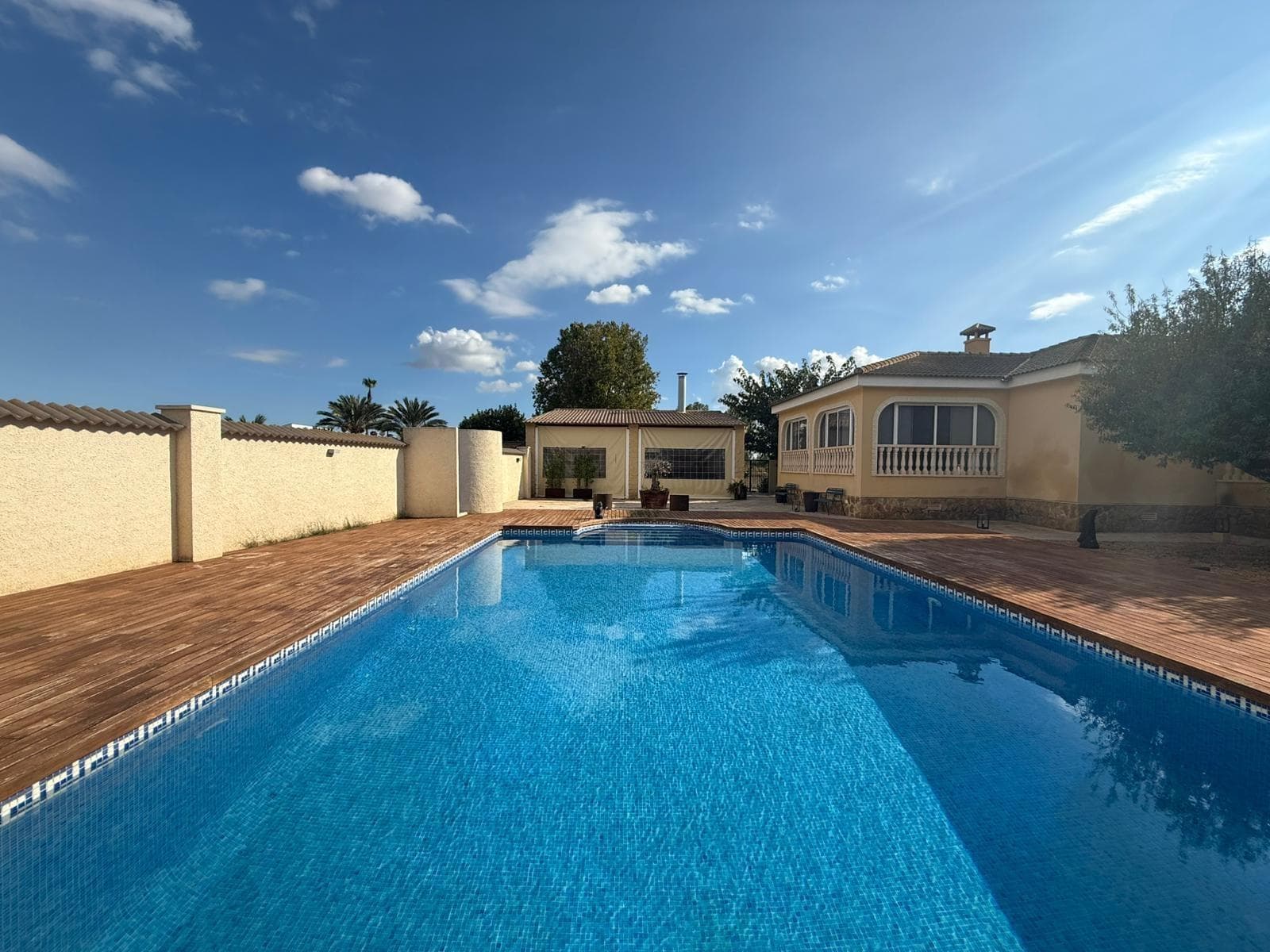 This property is presented located in one of the southern areas of the province of Alicante, between the towns of Callosa de Segura and Catral, in the heart of the Vega Baja countryside. A unique opportunity to acquire a completely renovated home, surrounded by nature, with excellent transport connections and ready to move into. The villa is set on an impressive 7,000 m² plot, fully utilized and equipped. Inside, the property offers 3 spacious bedrooms and 2 full bathrooms, a cozy living room ideal for relaxation, and a spectacular glazed terrace with direct views of the swimming pool and barbecue area, perfect for year-round enjoyment. It also features a solarium with panoramic views of the surrounding mountain ranges and farmland, providing an unbeatable environment of tranquility and natural beauty. Outside, the plot is divided into several areas: a well-maintained garden, a generously sized private swimming pool, a fully equipped barbecue area including a toilet and outdoor shower, and an extensive orchard where all kinds of fruits and vegetables can be grown. All of this is within a fully fenced plot with easy access. The property is sold fully furnished and equipped, ready to enjoy the excellent Mediterranean climate from day one, making it an ideal option both as a permanent residence or a second home. Located just minutes from towns such as Catral, Callosa de Segura, or San Isidro, the property offers proximity to all necessary services (medical centers, shops, schools, restaurants, etc.) and quick access to the A-7 motorway towards Alicante, Elche, or Torrevieja. A property that combines comfort, privacy, and direct contact with nature, in one of the most sought-after areas for those seeking quality of life and well-being. For more information, please do not hesitate to contact us.