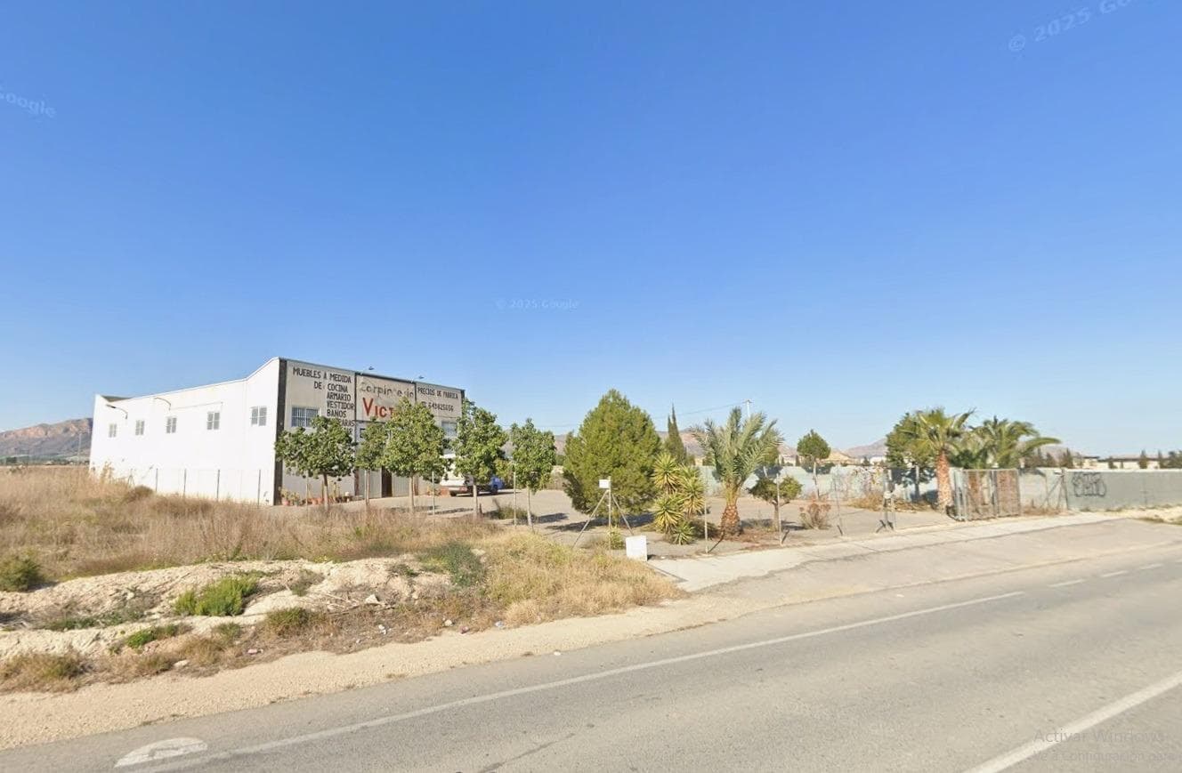 Excellent industrial warehouse of 400 m² for sale, currently operating as a carpentry workshop, ideal to continue the existing activity or to adapt it for multiple industrial, logistics, or storage uses. The warehouse includes an office and a fully equipped bathroom, making it fully operational from day one. Its structure allows for efficient use of space and potential modifications to suit the buyer’s needs. It is located on a total plot of 5,000 m², of which 1,500 m² are paved and fully fenced, providing a large area for maneuvering, parking, or loading and unloading. The remaining 3,500 m² correspond to rustic land, ideal as complementary space, future expansion, or outdoor storage area. The property enjoys an excellent location, directly on the main road, with very good access for all types of vehicles, including direct entrance to the warehouse through a designated gate. It offers open views, providing comfort, visibility, and a pleasant working environment. A unique opportunity for companies, self-employed professionals, or investors looking for a warehouse with a large plot of land, good accessibility, and multiple usage possibilities. CONTACT US!