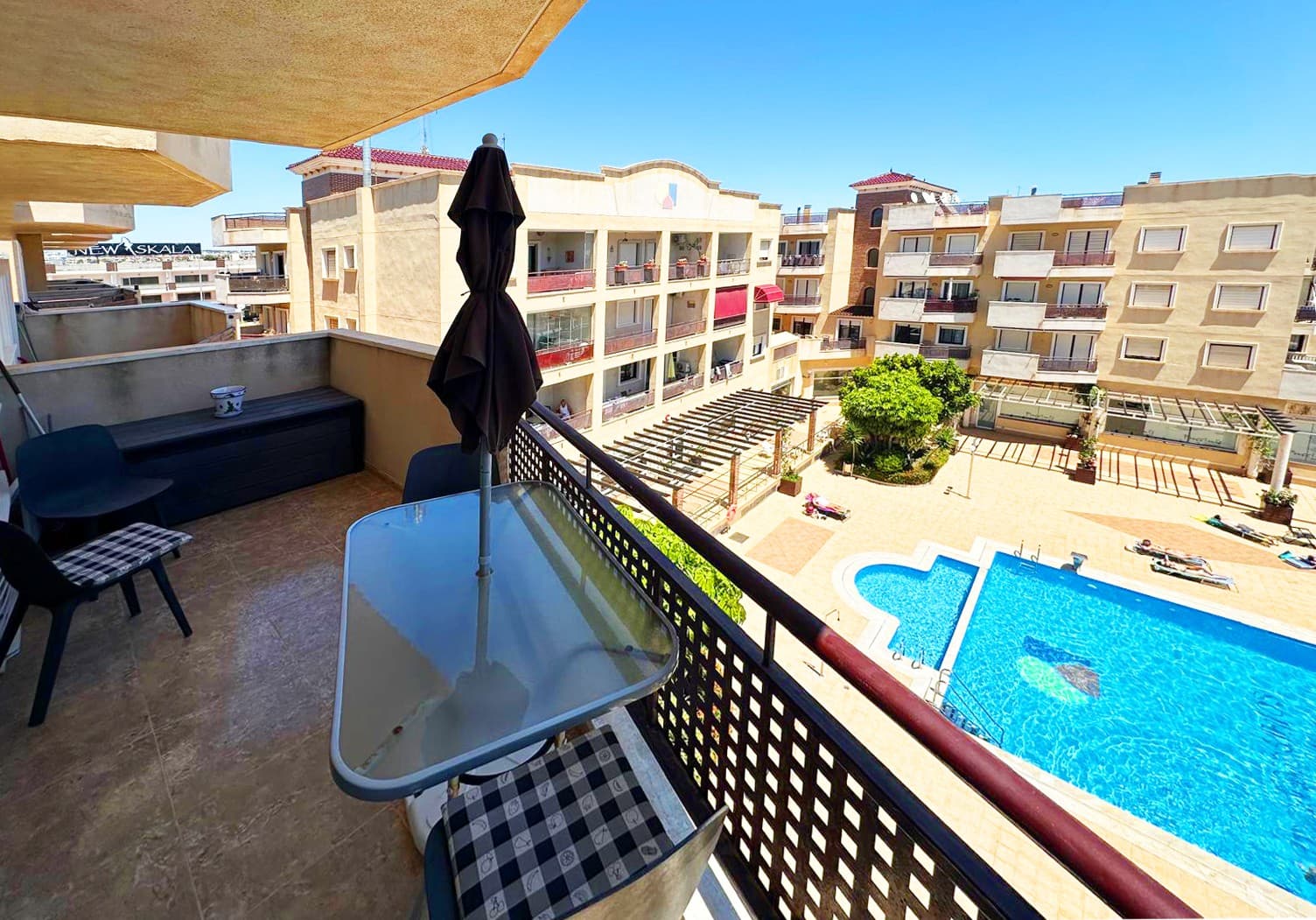 Ideal holiday home, or lucrative rental investment with very high rental potential! Spacious east facing 2-bedroom beachfront flat overlooking the communal pool in Residencial Costa Marina, Cabo Roig, just 200 metres from the seafront promenade and the coast. This property is located in the heart of Aguamarina, and the popular Cabo Roig strip with its numerous bars, restaurants and shops. Several beaches are within walking distance of the flat, including La Caleta (Cabo Roig), Aguamarina, La Glea and El Barranco (Campoamor). An ideal holiday home, or as a rental investment with very high rental potential. The complex is gated and offers a communal pool with lift access to all floors. The accommodation comprises an entrance hallway leading to the open plan living/dining room with a fully fitted kitchen, 2 bedrooms with fitted wardrobes and a family bathroom. From the living room you have direct access to a private balcony with amazing views of the pool area. The flat is sold furnished and with air conditioning, plus a private underground parking space is included in the price! The flat is located on the third floor and is connected the car park via a lift. In the immediate vicinity there are bars, restaurants, supermarket, medical centre, pharmacy, bus stop, etc. The weekly Thursday market is also nearby, not forgetting the blue flag sandy beaches of Cabo Roig, Aguamarina and Campoamor, which can be reached in 10-15 minutes on foot along the promenade.