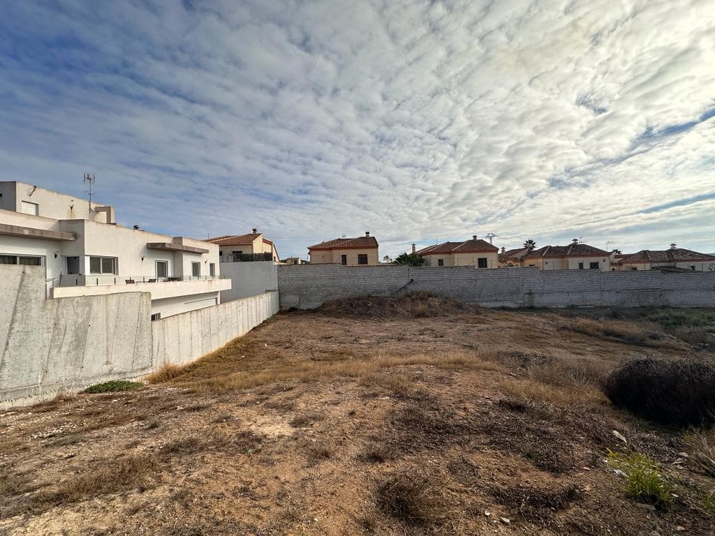 Unlock the potential of 501 m² in San Fulgencio, La Marina Alicante. This prime plot offers a blank canvas for your dream residence, blending modern luxury with the allure of Mediterranean living. Seize this opportunity to sculpt your vision in a tranquil locale, surrounded by the beauty of Alicante's La Marina. Your dream home begins here.

This plot has a building permit and an architect has already made a render of a possible modern house that can be built on it.

Maximum buildability: 0.348 m2/m2 (501 x 0.348 = 174.35 m2)

Maximum occupancy: 30% (501 x 0.30 = 150.30 m2)

Setbacks 3 m and maximum height 2 floors (7.00 m cornice height)

Underbuild does not compute towards m2



The plot comes with an existing project, valid until October 2024, featuring detailed floor plans for a 300m² property. The proposed design includes 150m² on the ground level and an additional 150m² basement, providing ample space for comfortable living. 



We can help you from the start to the end to develop your dreamhouse on this plot. We have a team of lawyers, architects and developers ready to accomplish your Spanish dreamhouse.

On walking and bicycle distance you have all the needed facilities like bars, restaurants, supermarkets, pharmacies, playgrounds, veterinarians,... you name it!

Feel free to contact us for more information.