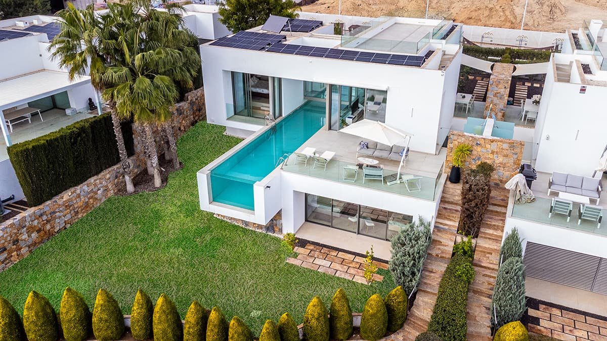 This luxury villa is located at Las Colinas Golf & Country resort located near Campoamor and the village of San Miguel de Salinas, 70 km south of Alicante.

 The golf resort is 330 hectares big and has besides the golf course a private beach club on the beach of Campoamor, a communal swimming pool, paddle fields, a fitness, tennis court, 2 nature trails and a mini supermarket. There are 3 restaurants: An Italian restaurant, a sushi restaurant and a club house with golf shop and changing room with showers. The entire domain is secured with its own security with camera surveillance at the entrance.

 The villa is located in the Limonero community which has direct access to the golf course. In front there are 2 private parking spaces and a beautiful front garden.

 Through the front door you enter the large living space with open kitchen, dining area, living room and a separate toilet with sink. The kitchen has all the necessary facilities and appliances (convection oven, dishwasher, microwave, fridge, 4 ceramic hobs and an air extraction system). Behind the kitchen there is a storage room with the necessary connections for the washing machine and dryer. Next to the kitchen there is a terrace with a table and chairs and a fireplace that is accessible through a sliding window. Through a glass walkway over the pool you enter the master bedroom with spacious built-in wardrobes and with private bathroom. Through the sliding window and the terrace at the bedroom you have direct access to the private pool. The large bathroom has a jacuzzi bath, a toilet, large walk-in shower and bathroom furniture with sink.

 Through the living space you can open the sliding windows completely so that you have direct access to the large terrace with a view of the golf and the sea. Through the terrace you can directly into the private pool that is located under the footbridge over the entire length of the house and can be beautifully lit in the evening. There is a BBQ area that can also be equipped with an outdoor kitchen and a shower. With the stairs up you come to the sun terrace with panoramic views over the golf with a view of the sea.

 On the ground floor there are 2 bedrooms with double bed and built-in wardrobes with sliding windows that have direct access to the terrace below and the large garden. There is also a bathroom with walk-in shower, toilet, bathroom furniture and sink. In addition, there is a large recreational room (mancave) and there are two large storage rooms where the technical installations for the swimming pool and the heat pump are located.

 The villa has all the necessary amenities: solar panels, air conditioning, alarm system, home automation system, internet and wifi. The house is sold including the furniture, but excluding the patio furniture and a few typical African pieces of furniture.