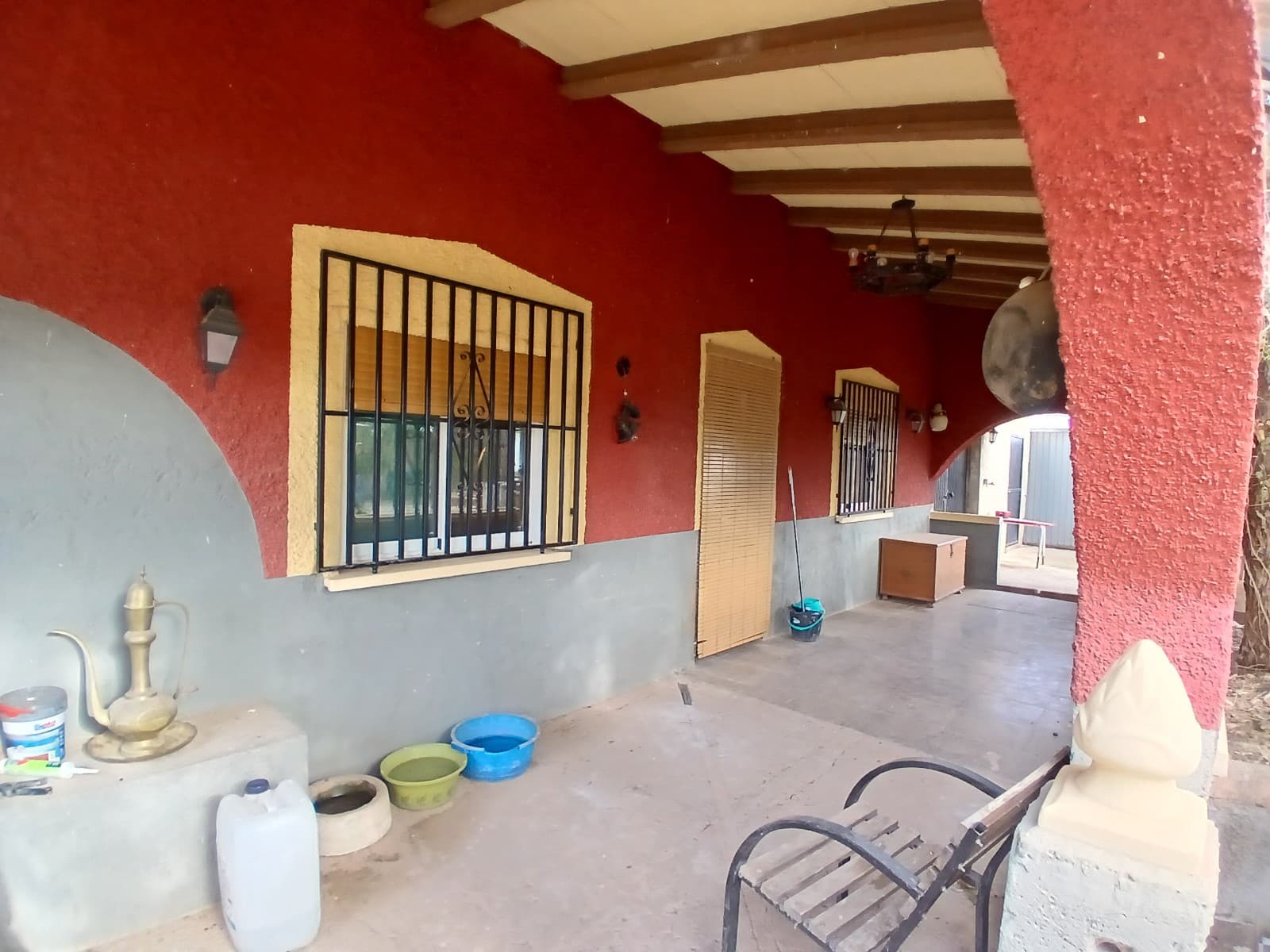 Country house located in a quiet location in Jumilla. The house has a large plot of 7.000 m2 with on it mainly mature olive trees. The plot is largely fenced. 

The house has two floors, the ground floor you enter through a covered terrace, the house enters into the open living room with American kitchen with bar and fireplace, this space is 32.9m2 and has air conditioning. The kitchen has a gas stove with oven and hood and is also room for placing a large fridge / freezer. 

There are 3 bedrooms (10.5m2,10.4m2 and 10.3m2) all with shutters and 1 with air conditioning. The bathroom is divided into 2 spaces, in the first space is a toilet, with sink and shower (the floor needs further tiling, the tiles are present for this), in the rear space is a recently masonry bath. This room also needs further finishing.

The upper floor is still only roughly constructed, currently without a staircase, where additional bedrooms or an apartment could be realized. 

The house is in good condition and has double glazing.

The garden near the house is poorly maintained and needs to be renovated. There are 2 garages, one of 21.5m2 and one for animal boxes 32.5m2.

There is enough space for a swimming pool and also enough plot, so getting a permit will not be a problem.

There is a cesspool / septic tank, irrigation water and fixed electricity connection. of