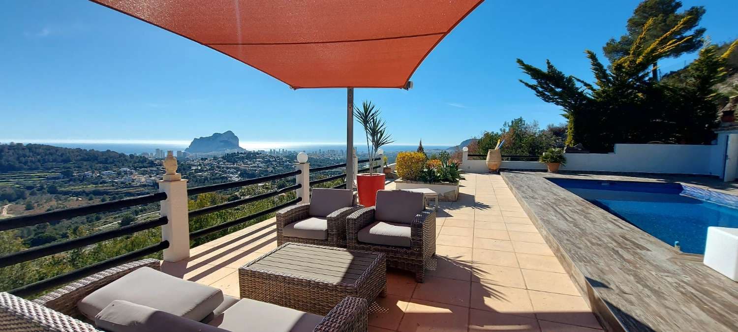 Villa for sale in Calpe, located in an established residential area, 5 km from Calpe's town center and its magnificent beaches, all kinds of shops, medical services, and a wide range of leisure and dining options.The villa has been completely renovated in a blend of modern and Mediterranean style and enjoys magnificent and incredible panoramic views of the sea, the Peñón de Ifach, and all of Calpe. Very bright (south-facing) and extremely private.The villa was built on a large 2,100 m2 plot and has a constructed area of 184 m2. Distributed over 2 floors:- On the main floor, we find the porch and a spacious entrance hall, the master bedroom with an en-suite bathroom and ample closet space, a storage room/pantry, a large living-dining room/kitchen (65 m2), and a porch that connects to the impressive 216 m2 outdoor terrace with an 8x4 meter rectangular pool, a wooden porch with a chill-out and relaxation area, an outdoor shower, a toilet, a summer kitchen and barbecue, a laundry room/machine room, and a storage room that also serves as a fourth bedroom. The upper floor is accessed via an internal staircase.- On the upper floor, we find the hallway, 2 spacious and bright bedrooms, and 1 bathroom with a shower.The villa has recently been completely renovated and stands out for its views, its light, its tranquility and privacy, and its magnificent outdoor areas.It is equipped with central heating (aerothermal heat pump system that offers the highest efficiency and best performance) and air conditioning. It also has a large outdoor parking area for two vehicles (sail-covered), strategically located next to the main entrance. The low-maintenance garden, abundant with plants, has a waterfall in the pool area, and a chill-out terrace to enjoy the more than 300 days of sunshine a year that Calpe offers.We invite you to discover this magnificent villa. You won't be disappointed.
