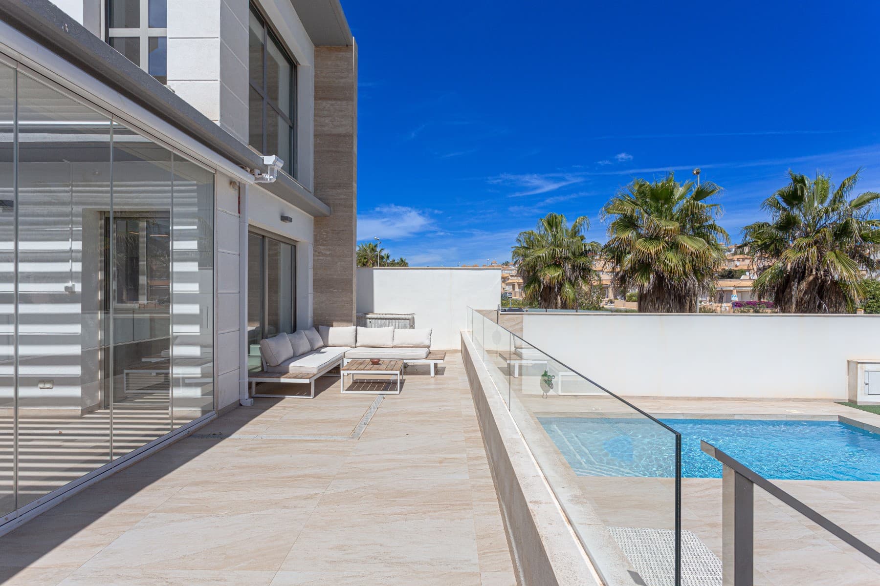 Modern villa for sale in Villamartin, Orihuela Costa, built in 2019, featuring 4 bedrooms, 3 bathrooms, private pool, solarium, and solar panels. With 150 m² of living space on a 320 m² plot, this property offers a spacious and elegant layout across three levels. The ground floor includes a bedroom and a bathroom with walk-in shower; upstairs you’ll find two more bedrooms, another bathroom, and access to a sunny terrace and private solarium. The basement adds extra versatility with a fourth bedroom, a third bathroom, and a generous living area.This south-facing villa comes almost fully furnished and includes a bioclimatic terrace, private parking, and a large outdoor area perfect for relaxing or entertaining. Energy-efficient thanks to solar panels, a battery system, and an EV charger, this is an ideal eco-friendly home.Located close to golf courses, beaches, international schools, and all amenities, it’s perfect as a permanent residence, holiday home, or investment property in Costa Blanca. Don’t miss this opportunity—contact us today to arrange a viewing!
