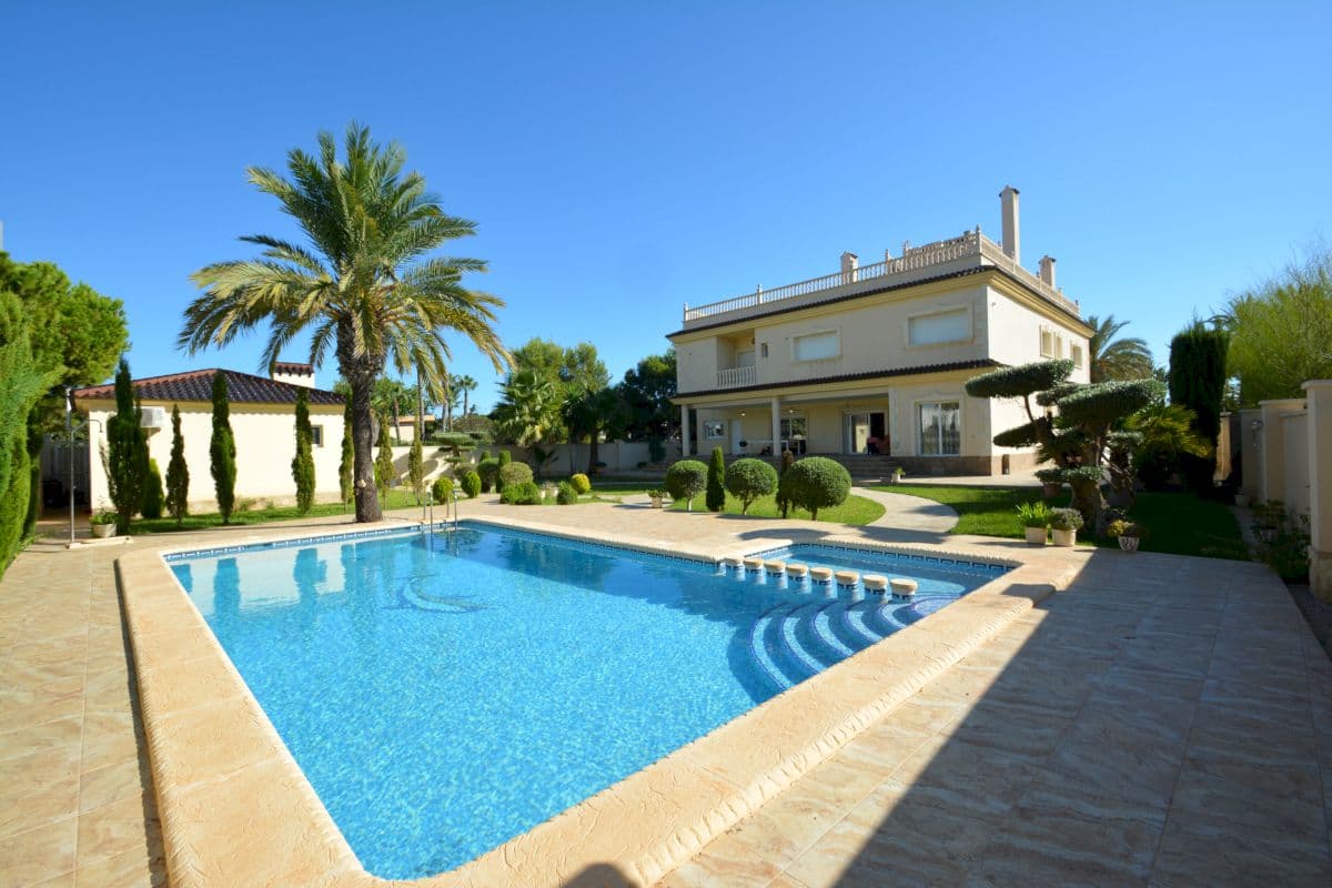 Stunning customised villa built in 2016 on a 1355 m2 plot just a few steps away from the sea. Top quality materials and finishes. Marble floors, PVC windows, diesel heating throughout the house. Centralised air conditioning with heating and cooling modes, and zoning option , which allows to direct hot or cold air to specific zones of the house. 

511 m2 of total constructed are, which is distributed between 2 level + roof terrace. 

Main entrance on the ground floor leads to wide entrance hall with a beautiful wall-painting. The entrance hall continues to luminous living room with dining area and fireplace. From the living room it is possible to out onto a large porch which faces the garden and the swimming pool. Double kitchen is also located on the ground floor with big utility room and walk-in closet. On the right hand from the entrance door we will find the master suite with 2 addition office type rooms, spacious private bathroom and a big walk-in closet. 

First floor has 2 single suites and 2 double suites. In total there are 10 bedrooms, 6 bathrooms and 1 restroom in the house. This villa's layout allows to convert into a boutique hotel or a business project to offer a perfect venue for private events. All bedrooms have walk-in closets. 

120 m2 roof terrace with amazing panoramic views. Lovely landscaped garden with big private pool with children section. Guest/staff house is built on the plot with a separate apartment for guests or housekeeping staff. The apartment has a bathroom, kitchen and a small sitting area. Also another separate bathroom is available in the guest house. The technical room with all the machinery is situated in the basement of the guest house. 

Parking space for 2 cars on the plot. Will be sold partially furnished. All electric appliances are included in the price. 

The house is situated just 50 meters from Cabo Roig beach, in the most privileged area of Orihuela Costa. All services and amenities are situated quite close. The best golf courses are situated within a 10-15 minute drive. 1-hour drive to Alicante airport. 

Please contact us to request more information or to arrange a viewing. 

