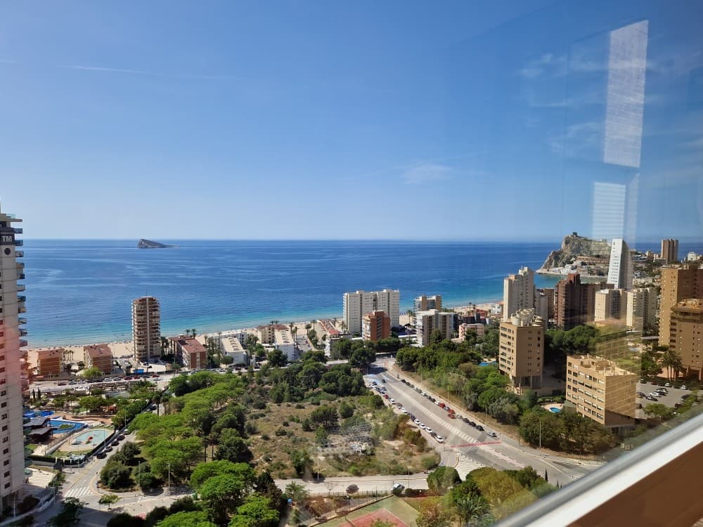 Delux Apartment on Benidorm Beach. This absolutely exclusive property stands out for its spacious and comfortable design, with a surface area of &8203;&8203;161 m², ideal as a first or second home, or even as an investment. It has 4 bedrooms (one en suite) and 3 bathrooms. All rooms, including the living room, are completely exterior and offer spectacular views of the sea, mountains, and city, creating a perfect setting for relaxation.The fully furnished and equipped kitchen features an induction cooktop, oven, microwave, dishwasher, refrigerator, and washer-dryer. It boasts mountain views and a functional laundry area. The home features ducted air conditioning (hot/cold), impeccable electric awnings, two-tone metalwork (white inside and brown outside) with tilt-and-turn windows, wood-effect ceramic flooring, a security door, a safe, and a television.Domestic hot water is produced using city gas. In addition, the built-in cabinets distributed throughout the rooms provide optimal storage spaceThe development offers excellent common areas designed for the well-being and enjoyment of its residents: extensive gardens with natural grass and trees, a large lake-style pool, a tennis court, a sauna, a gym equipped with various machines, and a children's area. The spacious outdoor parking lot is equipped with video surveillance cameras for added security.Located just a 7-minute walk from the beach, with all amenities and public transport within reach, this property is ideal for those who value exclusivity, style and a high quality of life.